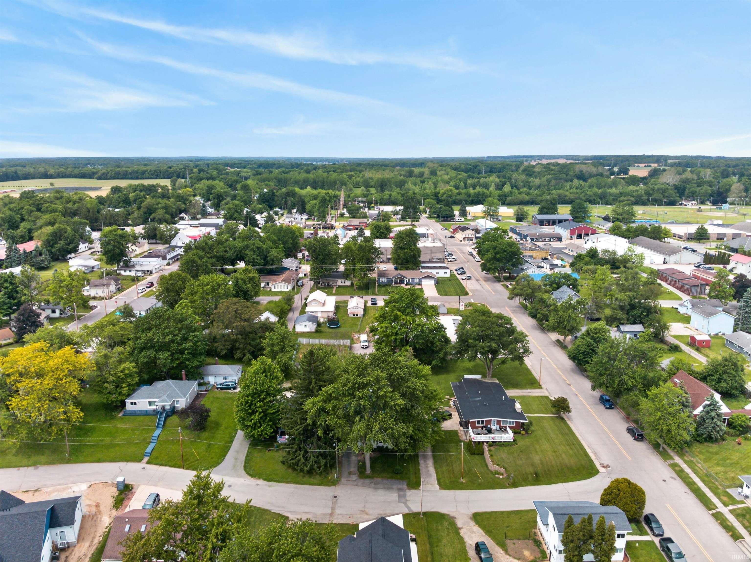 Residential neighborhood with mature trees and a clear sky overhead