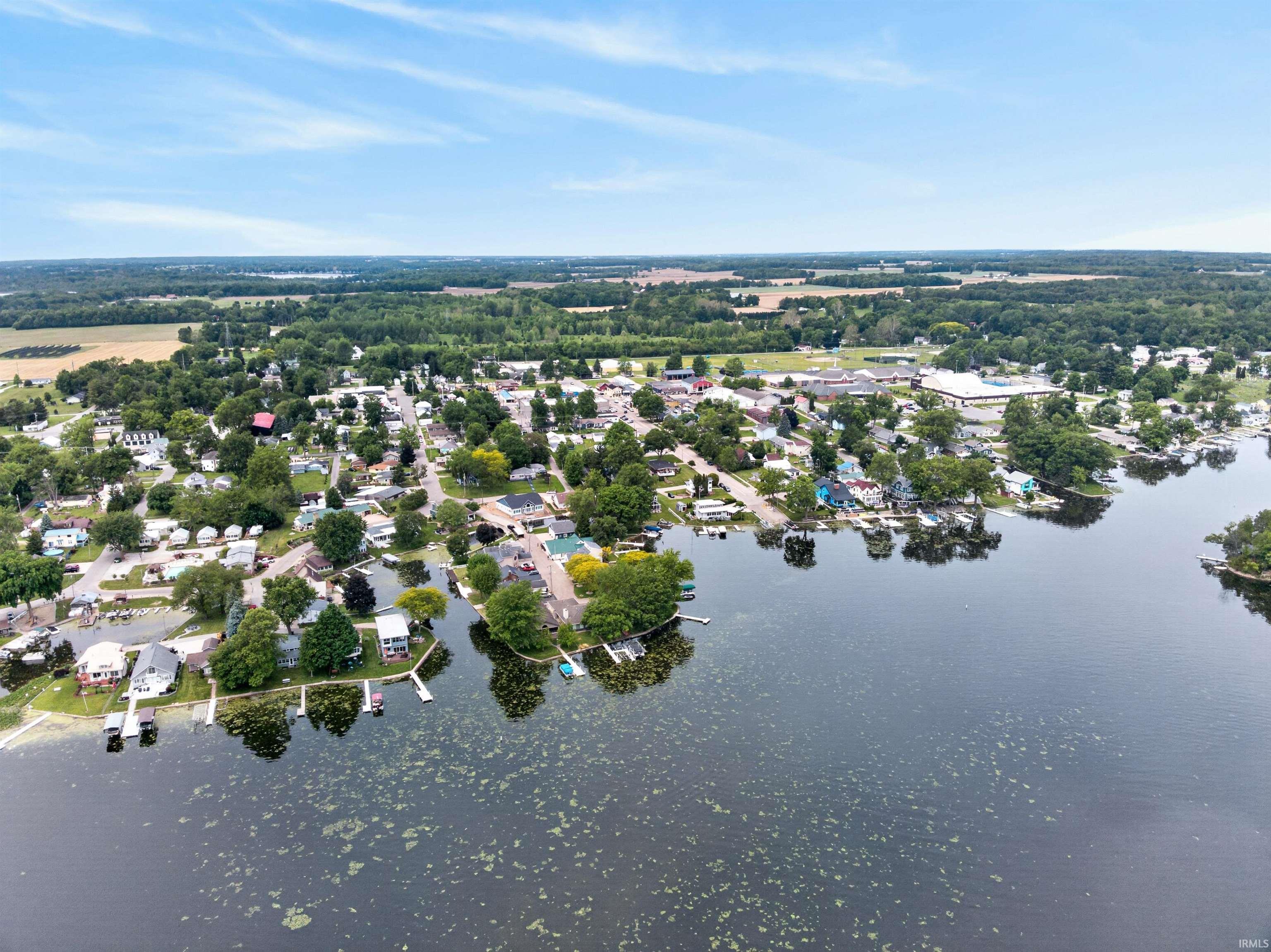 Aerial perspective showcasing a waterfront community with numerous properties featuring private docks