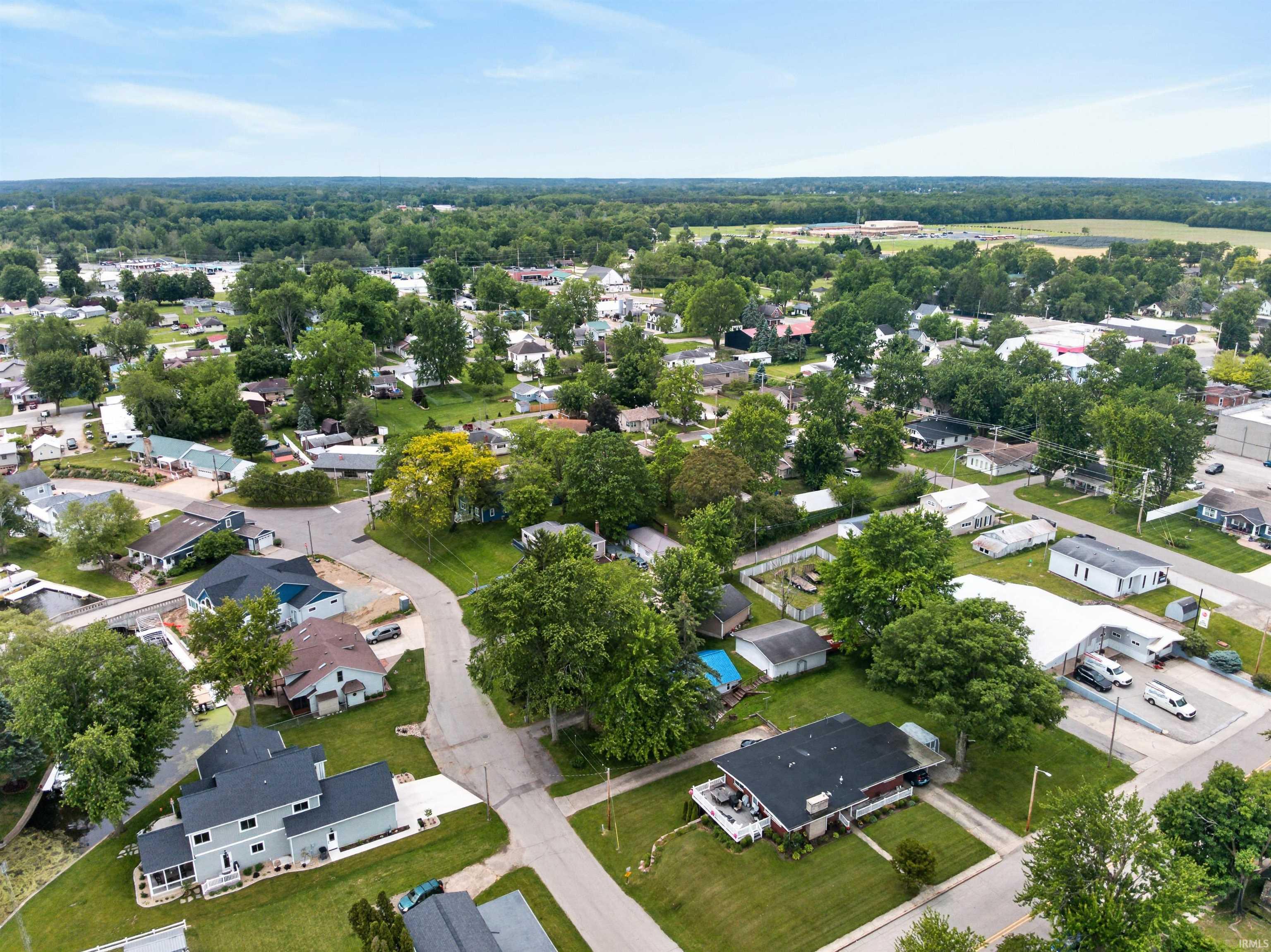 Aerial perspective showcasing a residential neighborhood with mature trees and a varied architectural landscape