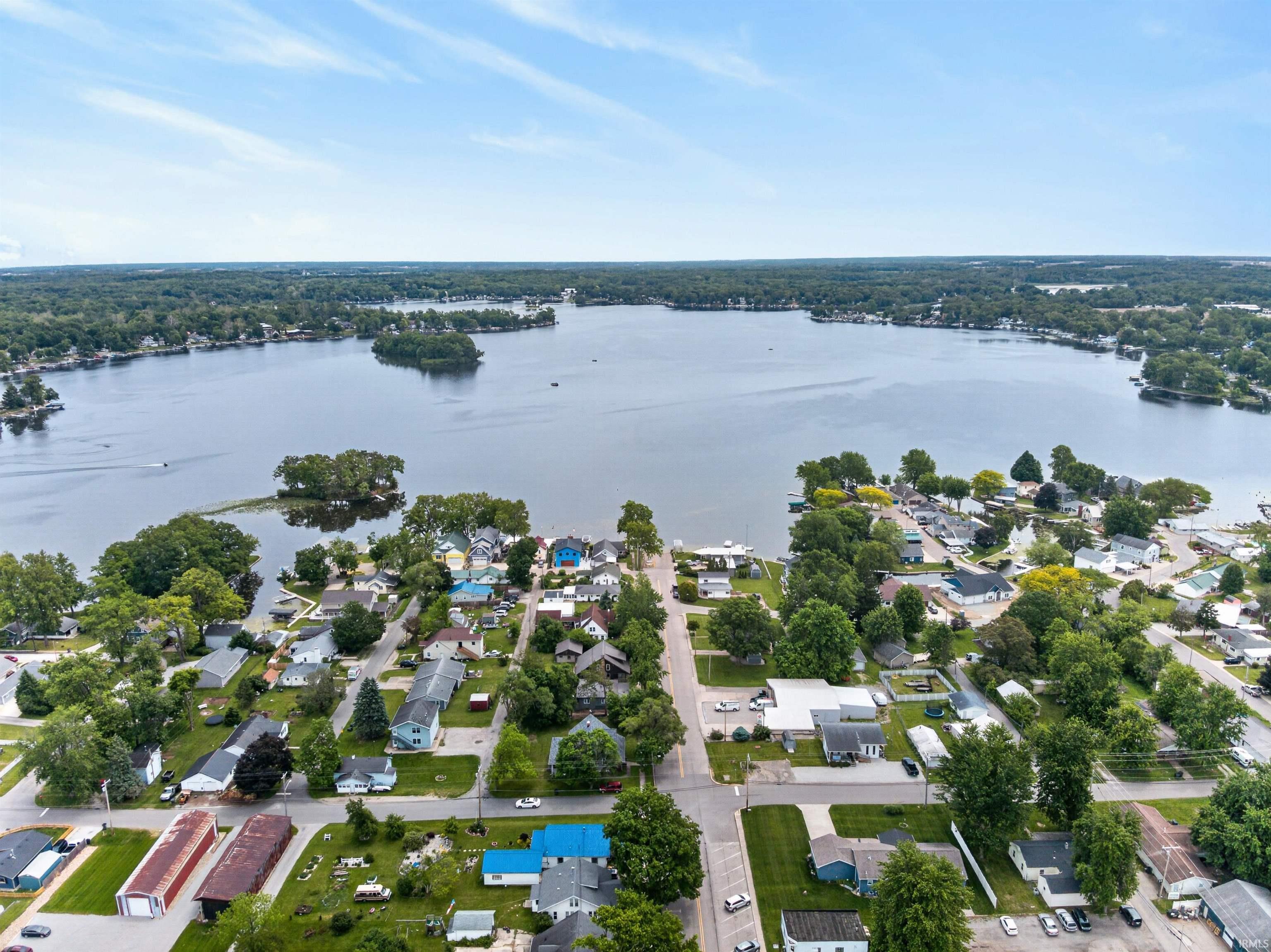 Expansive lake surrounded by residential properties and mature trees