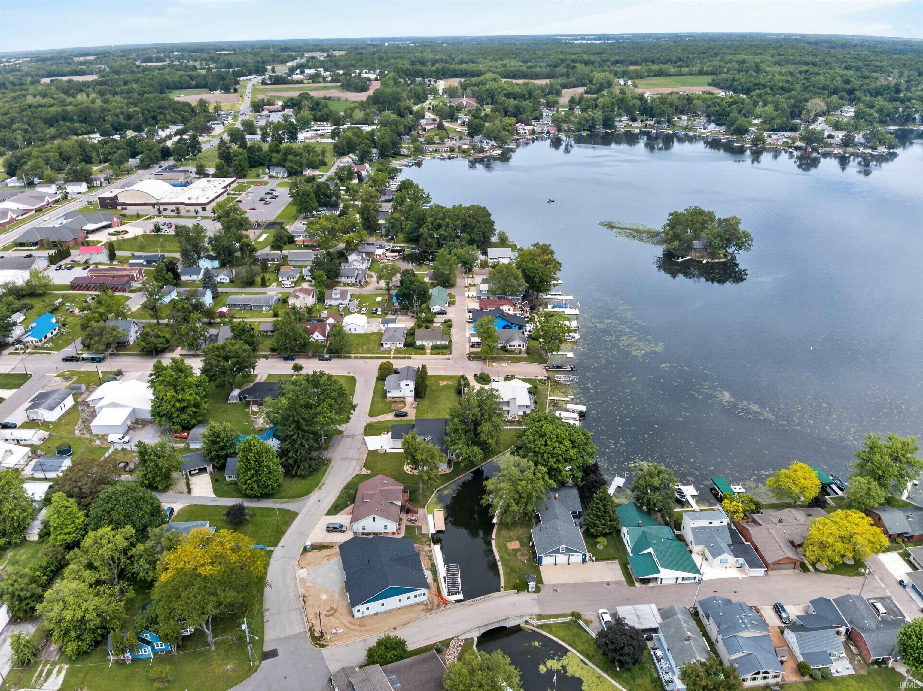 Aerial perspective showcasing a residential area with lake frontage