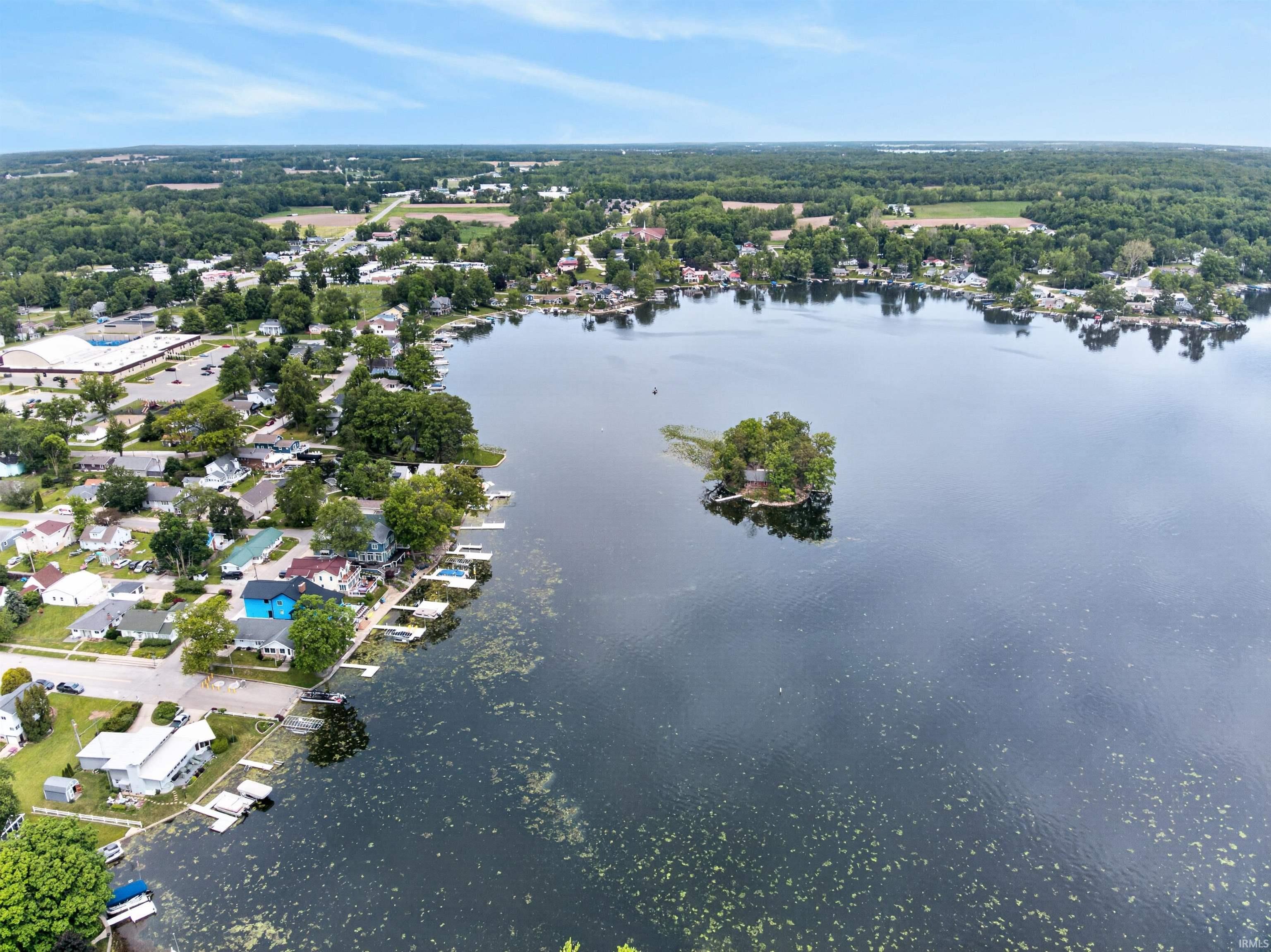 Aerial perspective of a lakefront community featuring a prominent body of water