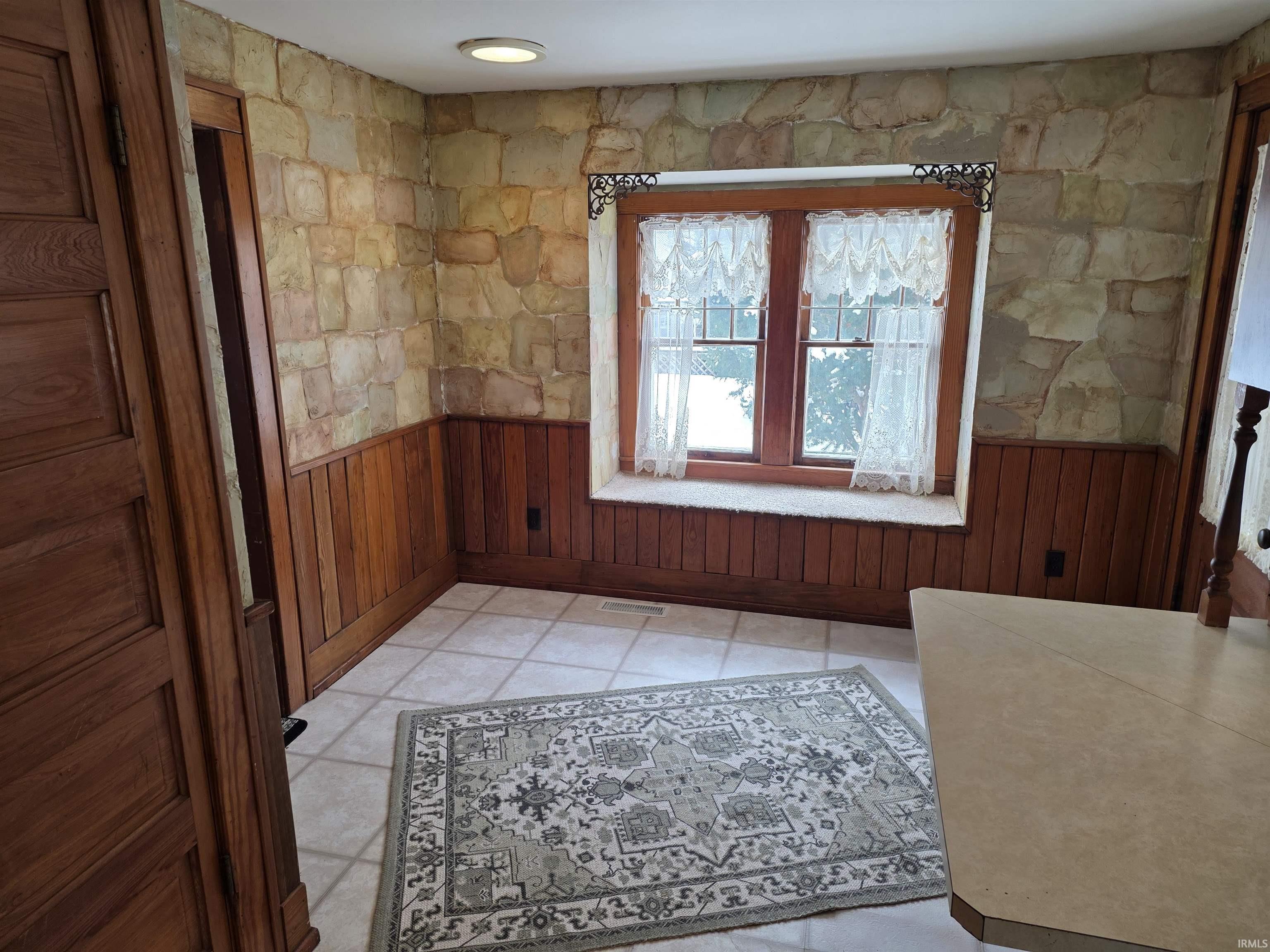 Interior space featuring wainscoting and wooden walls