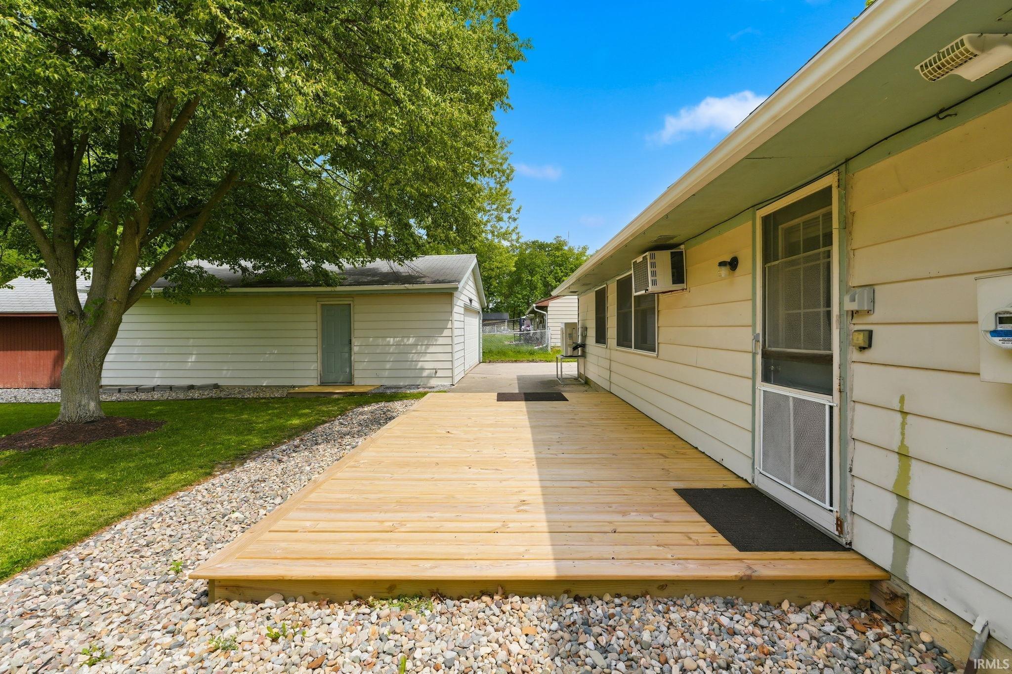 Expansive wood deck with a gravel border