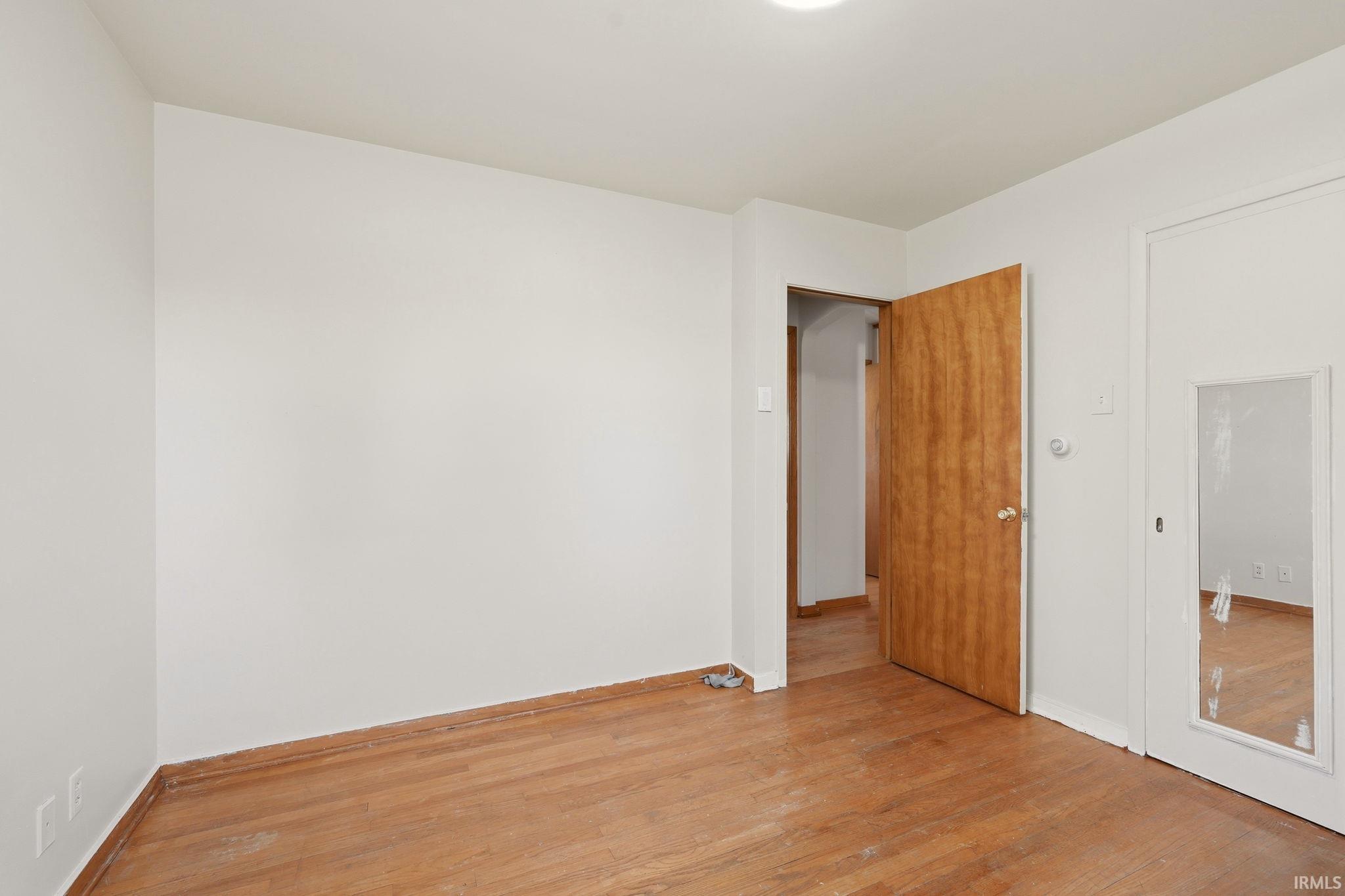 Neutral white walls with wood-finish flooring