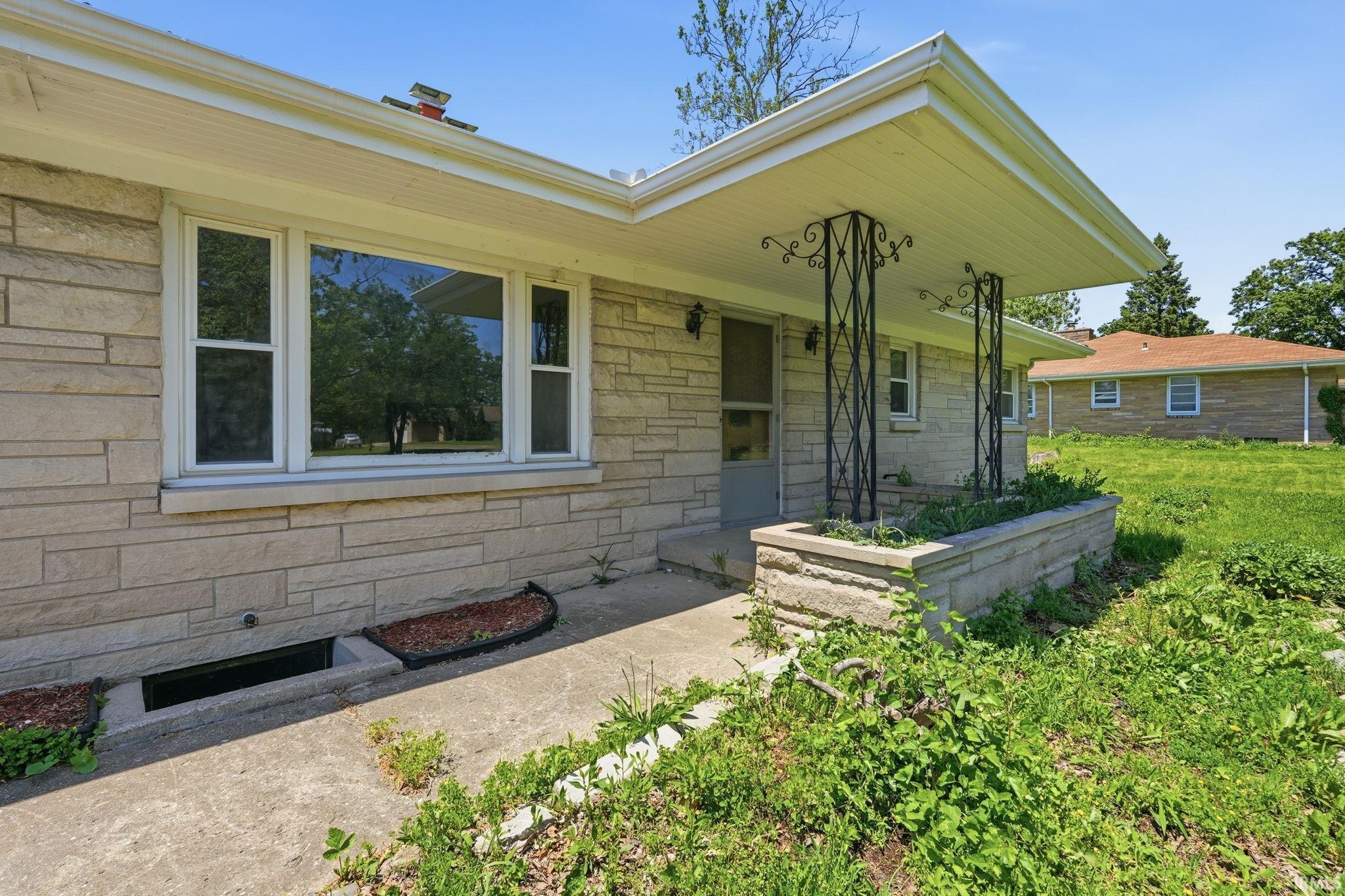 Stone veneer facade with a covered porch entry