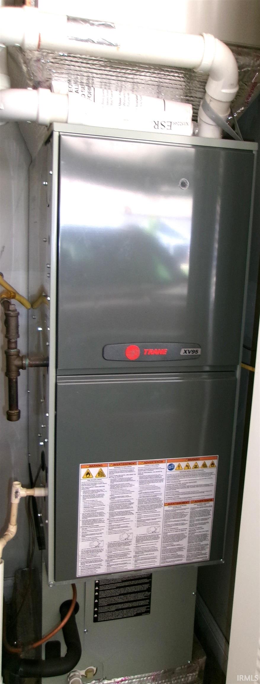 Vertical furnace unit with exposed piping and ductwork