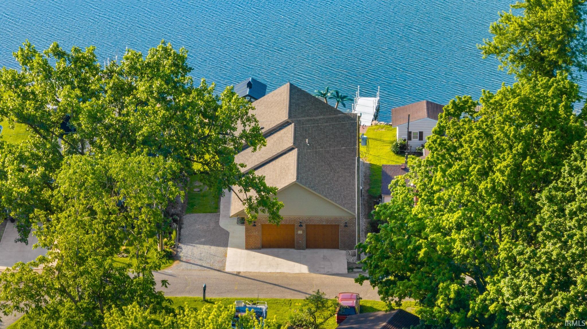 Waterfront property featuring a multi-level structure with a gabled roof