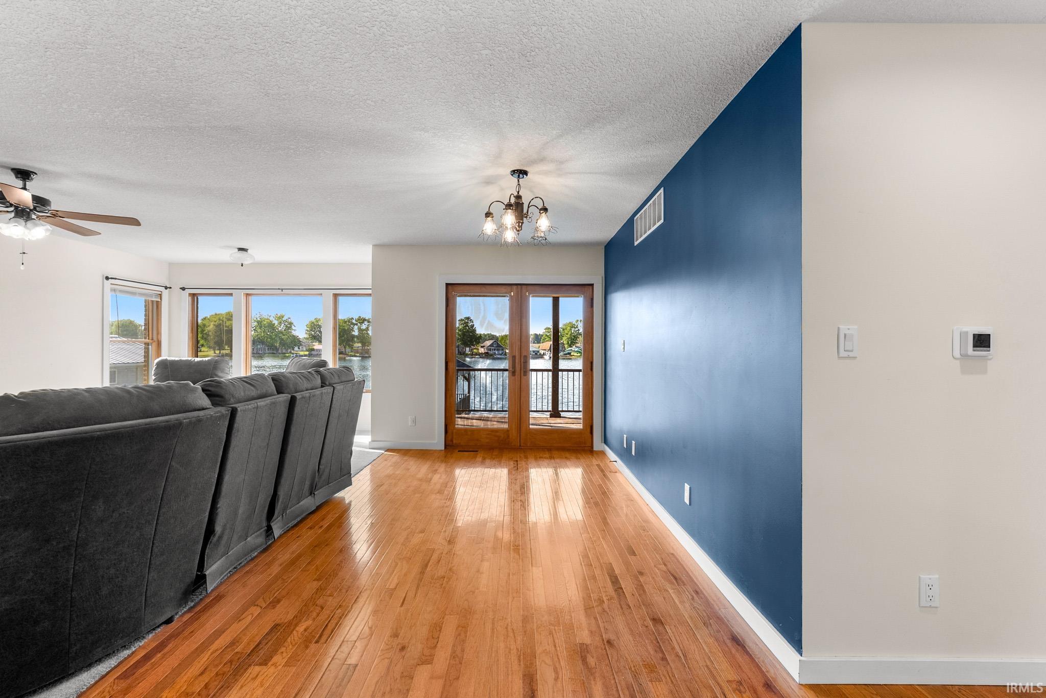 Hardwood flooring throughout, with a rich blue accent wall