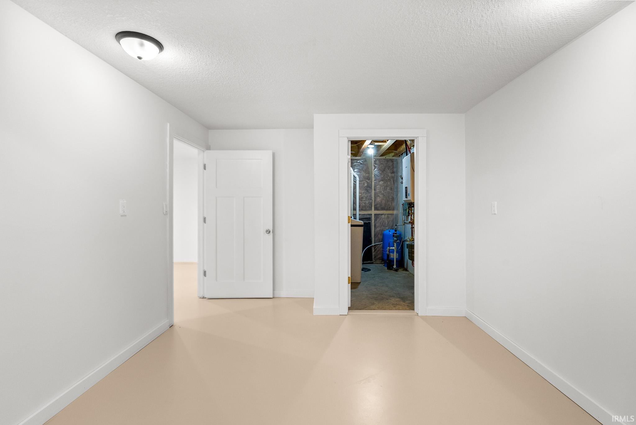 Bright white walls and trim create a neutral palette, complemented by a light-colored floor