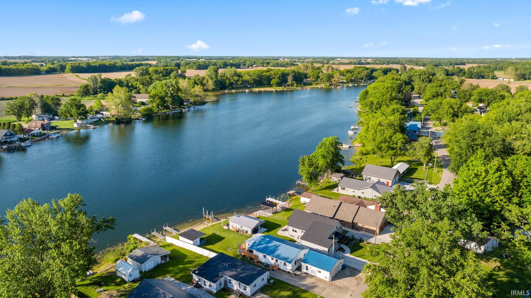 Waterfront properties with private docks, surrounded by mature trees and residential landscaping