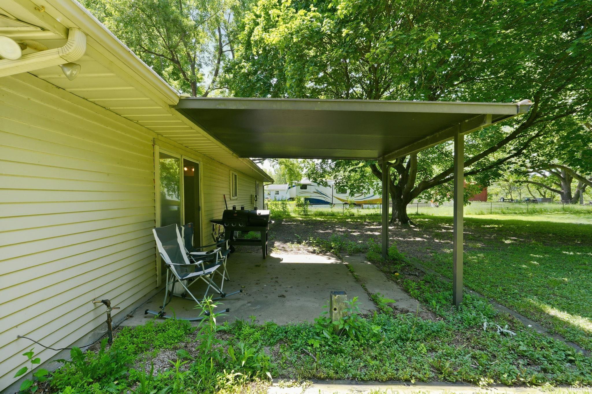 Covered concrete patio with direct access to interior via sliding glass door