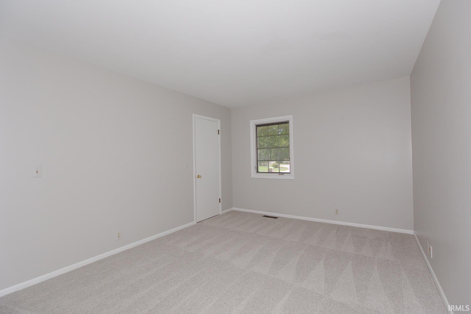 Neutral wall tones with light-toned carpeting and white trim