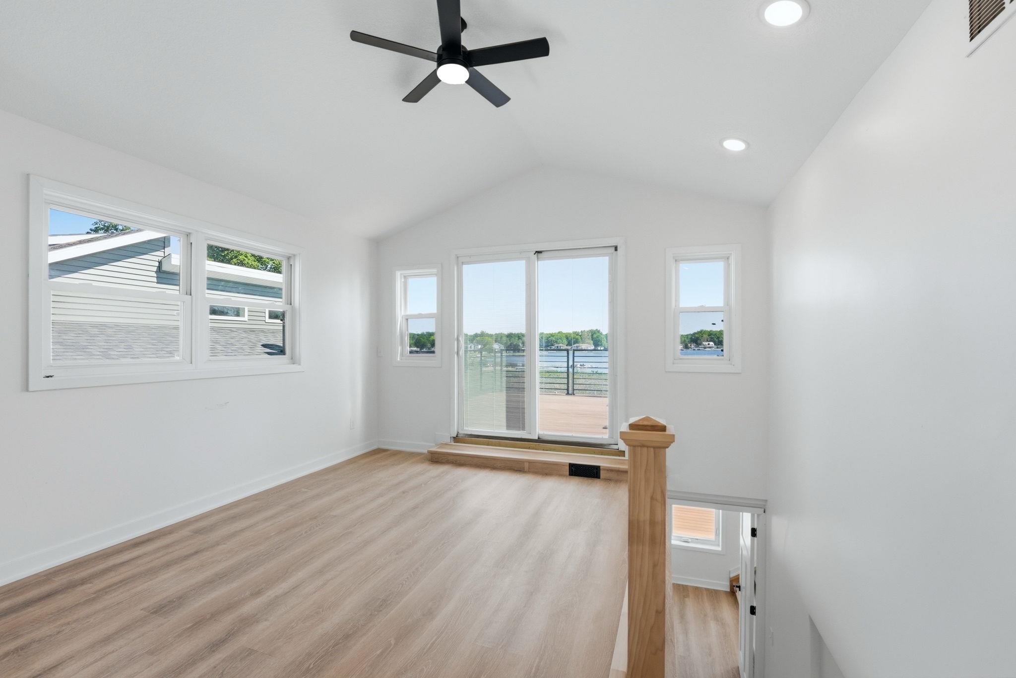 Vaulted ceiling featuring a black ceiling fan and recessed lighting