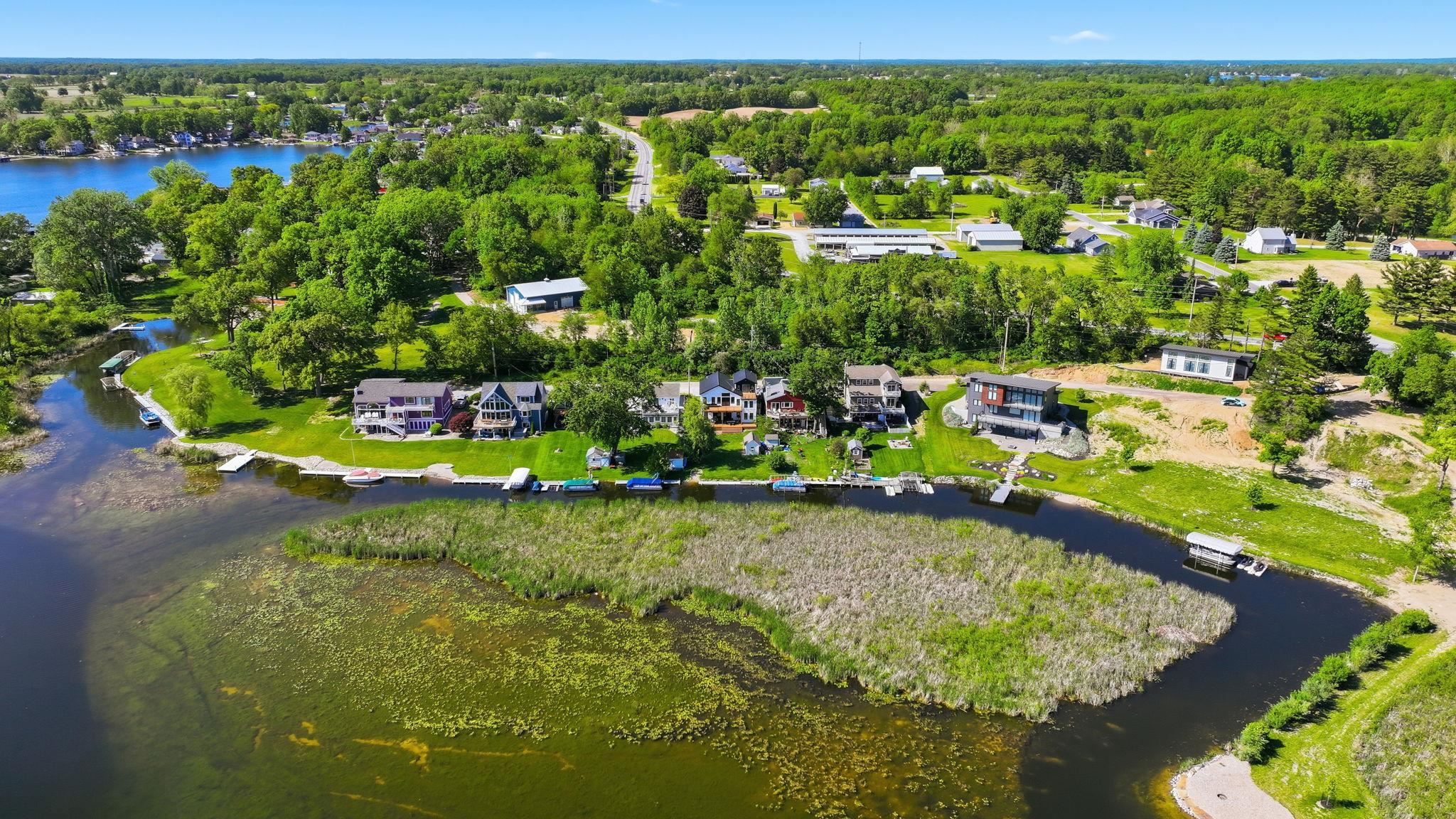 Waterfront properties featuring direct water access, private docks, and substantial green space