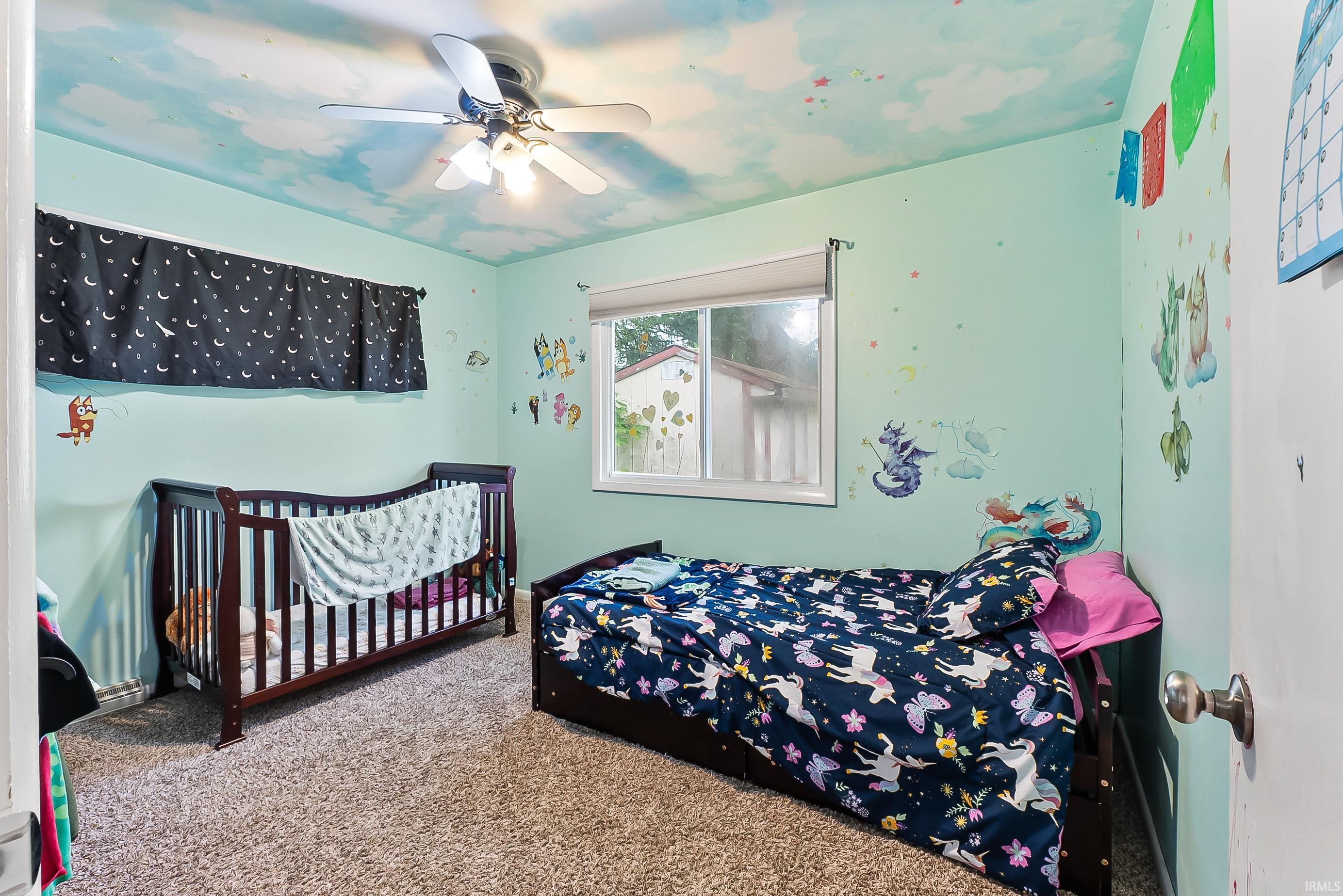 Room with light green walls and a ceiling fan