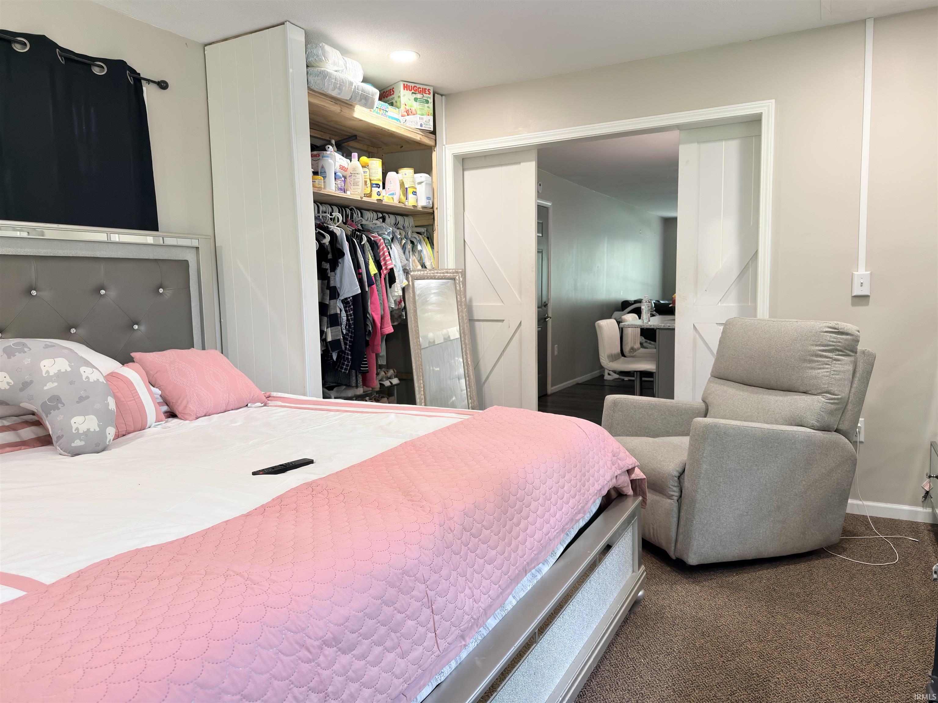 Built-in closet with wood-finish shelving and hanging rods