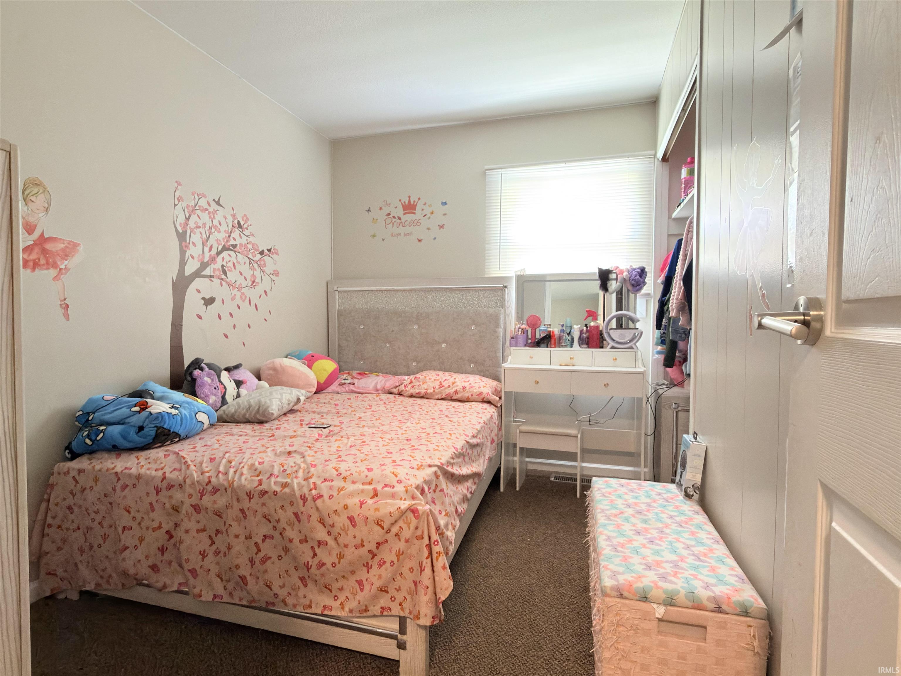 Bedroom featuring carpet flooring, a window with blinds, and white painted walls