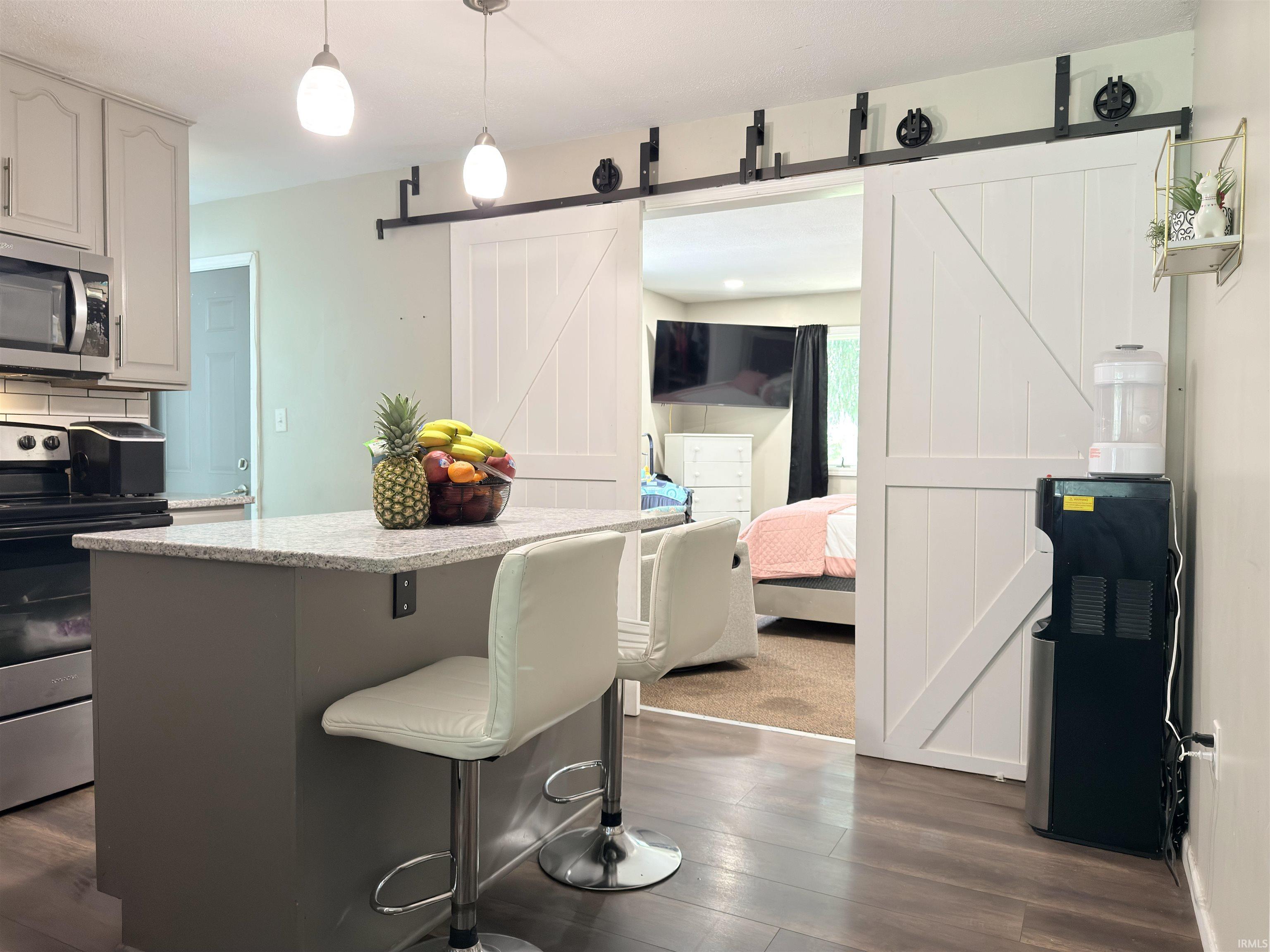 Kitchen island with a light-toned countertop and pendant lighting