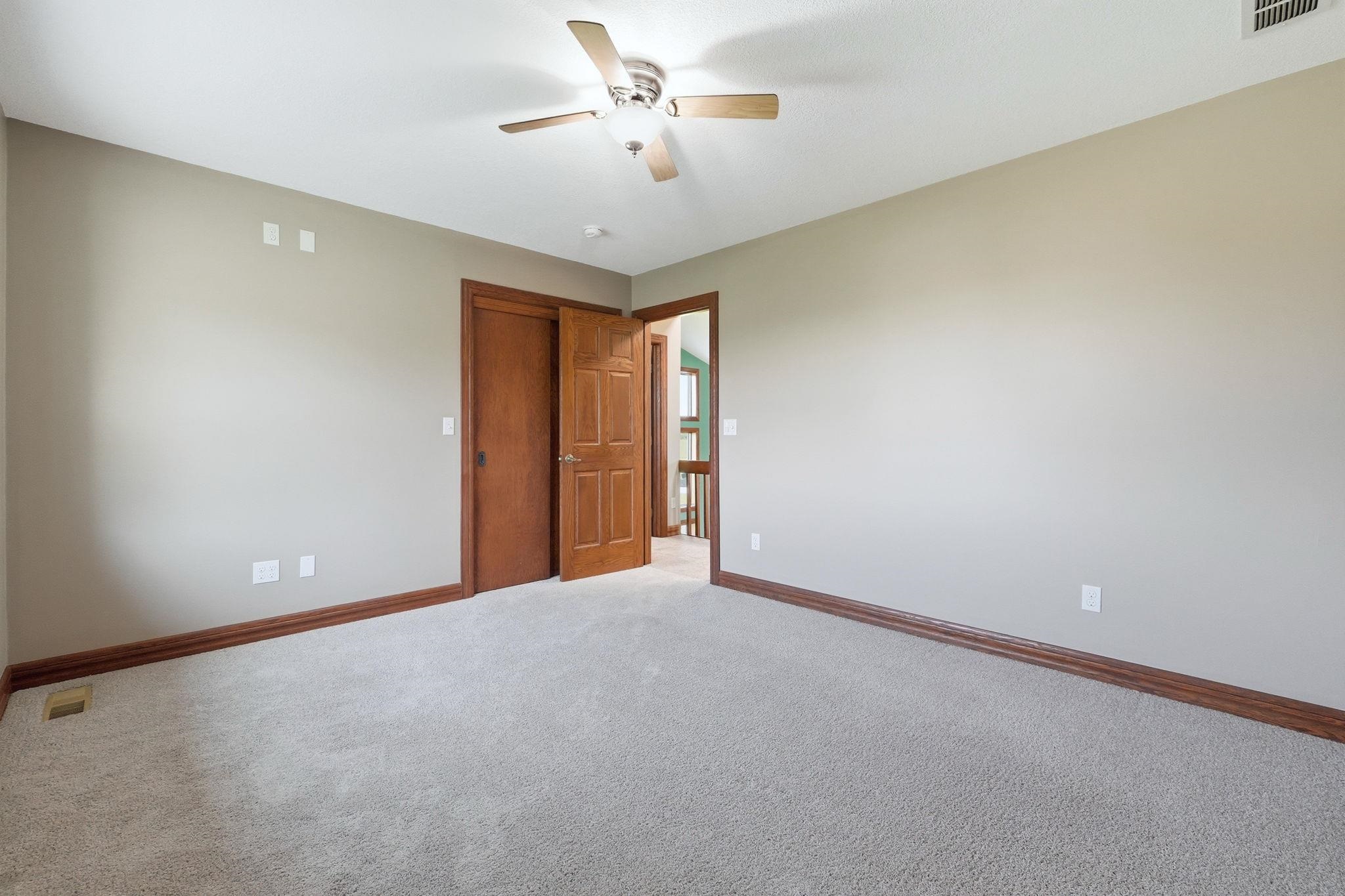 Neutral wall paint with contrasting wood-finish baseboards and door frames
