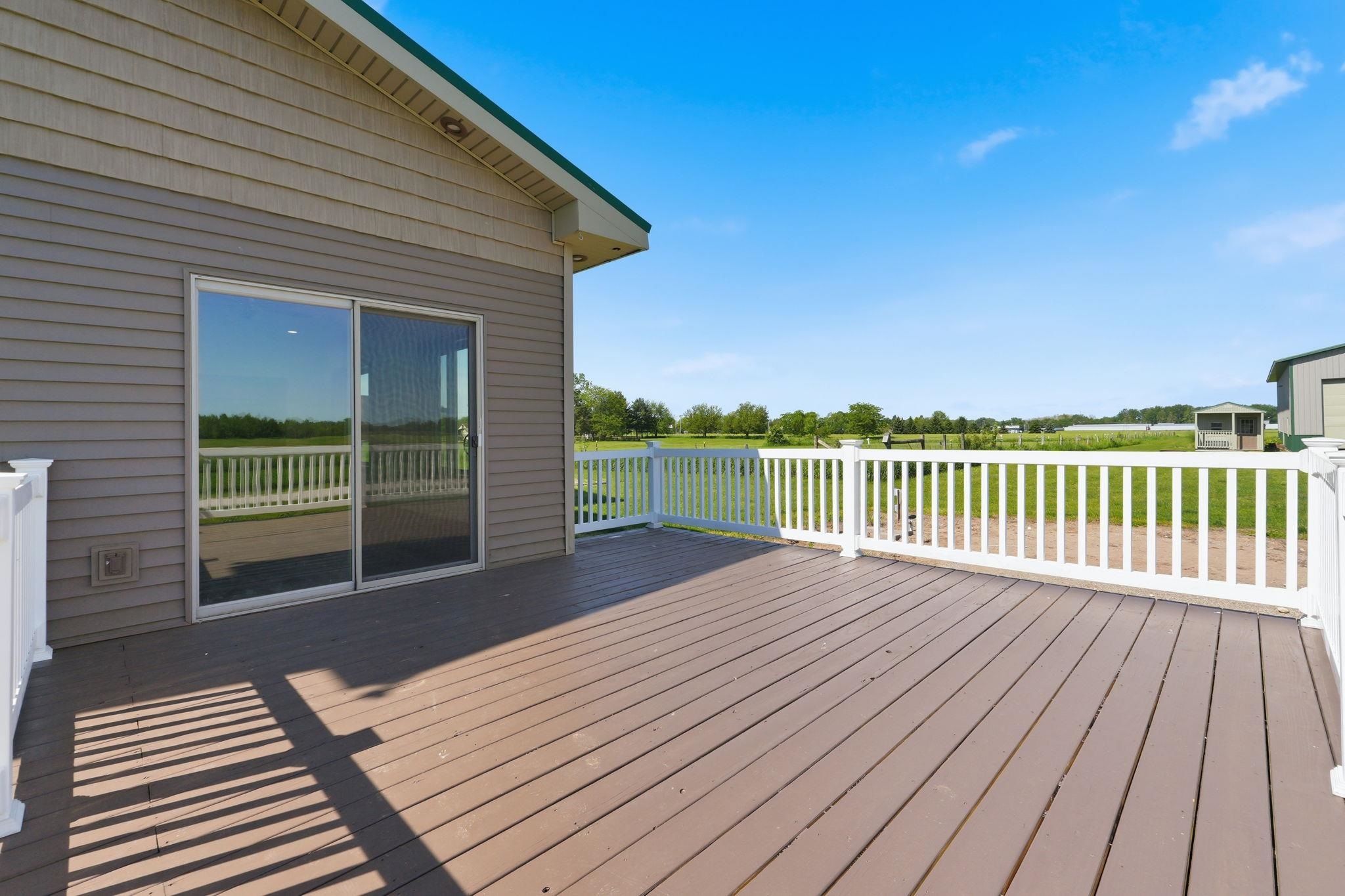 Expansive exterior deck featuring composite decking and white railings