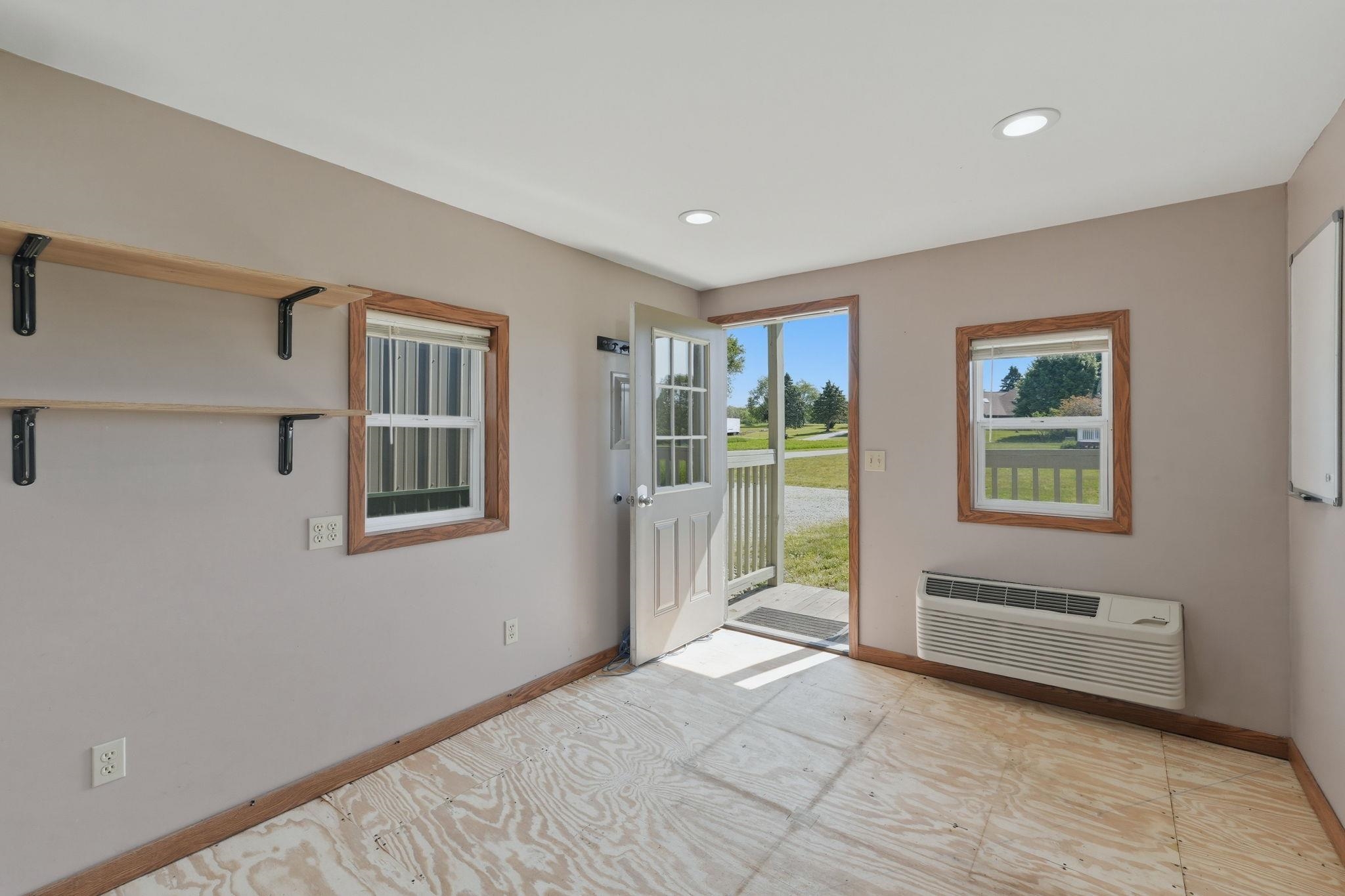 Interior space featuring exposed subflooring, recessed ceiling lighting, and light-toned wall paint