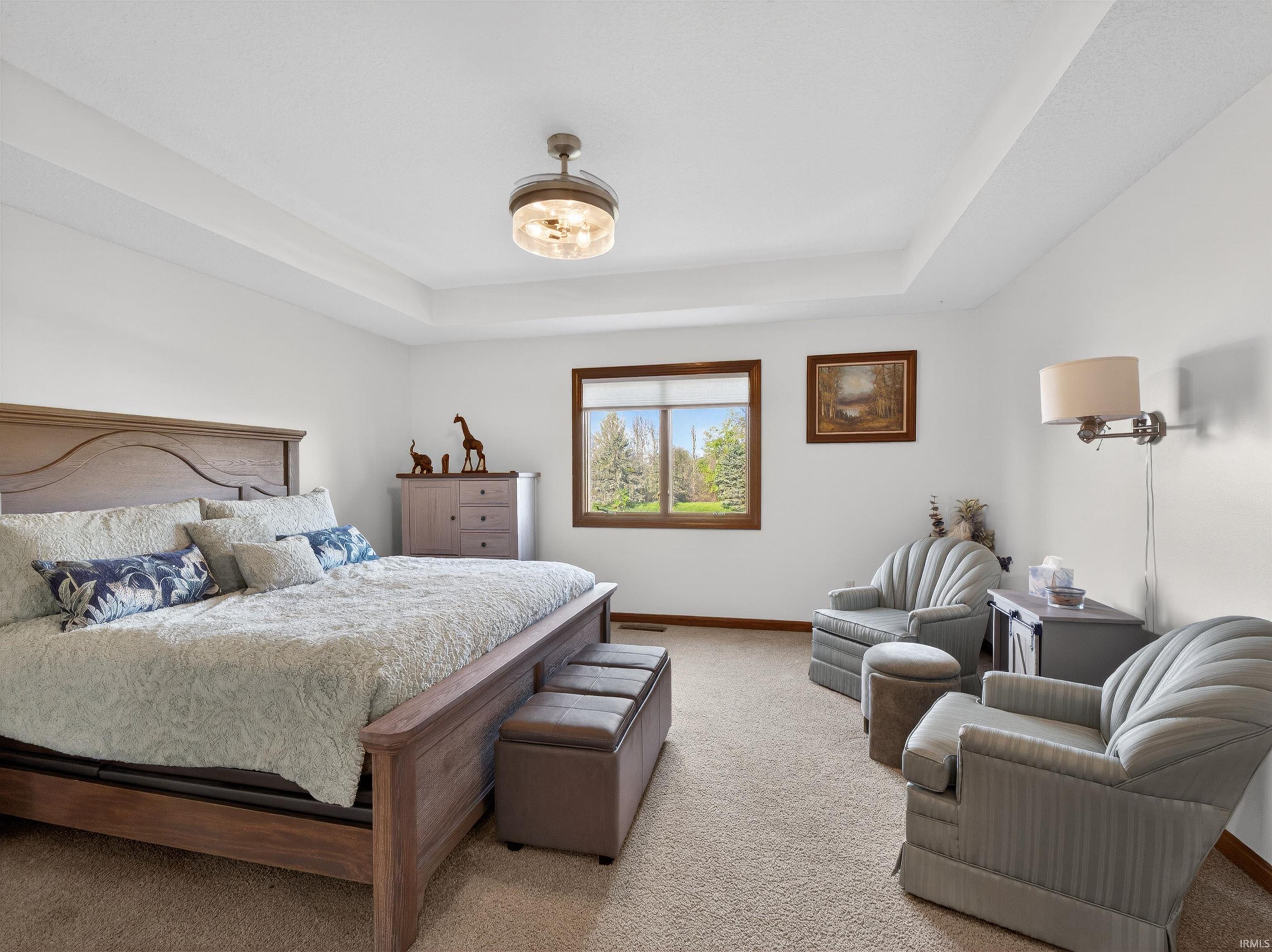 Spacious room with a tray ceiling