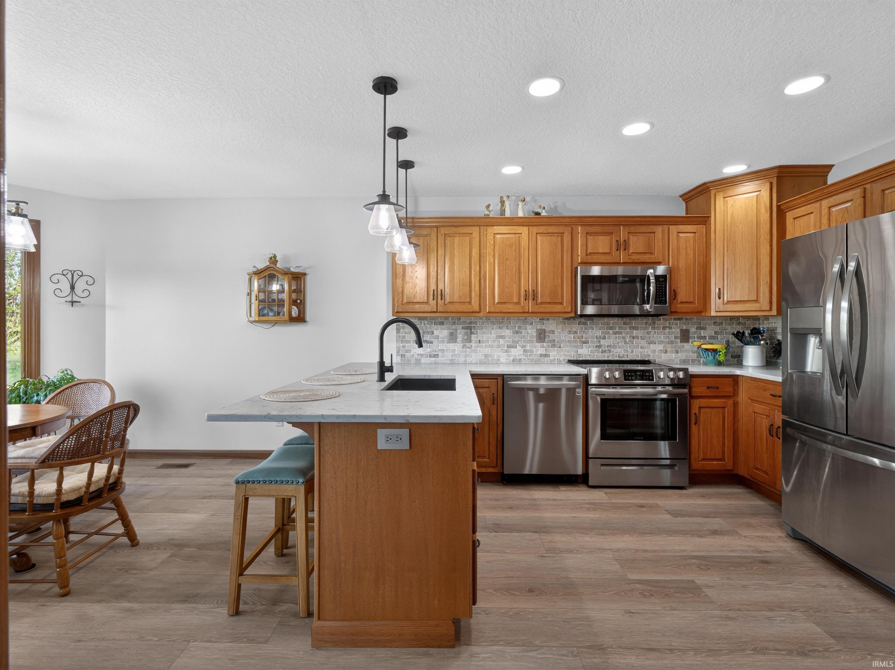 Kitchen featuring recessed lighting, and a center island with pendant lights, CORNER PANTRY, AND PULL OUT SHELVING STORAGE.