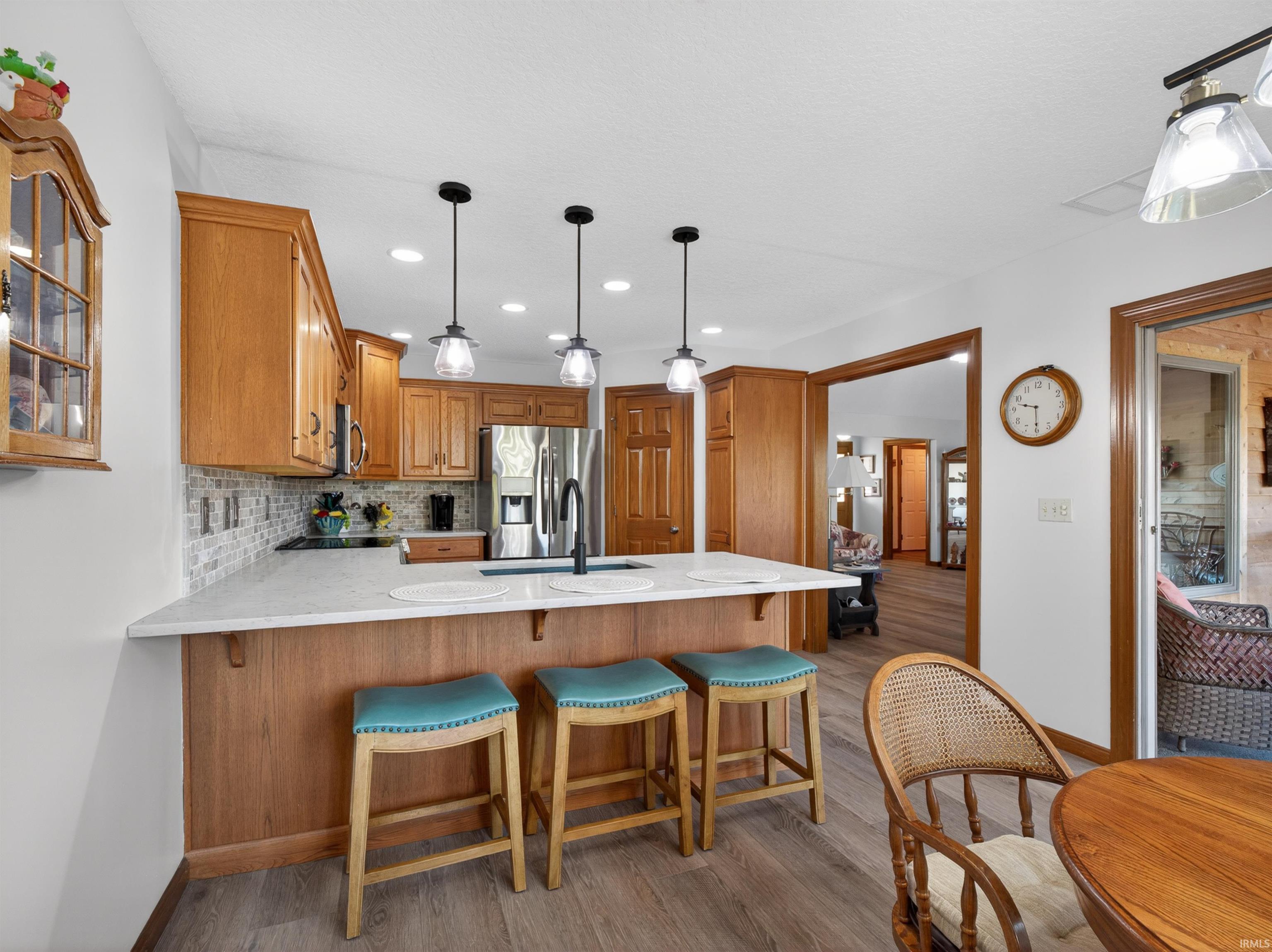 Kitchen featuring GRABILL cabinetry, QUARTZ countertops, custom paddle light switches, light-grey subway tile backsplash, TOP OF THE LINE APPLICANCES, stainless steel, slide in electric range, sliding pullout shelving, huge corner pantry.