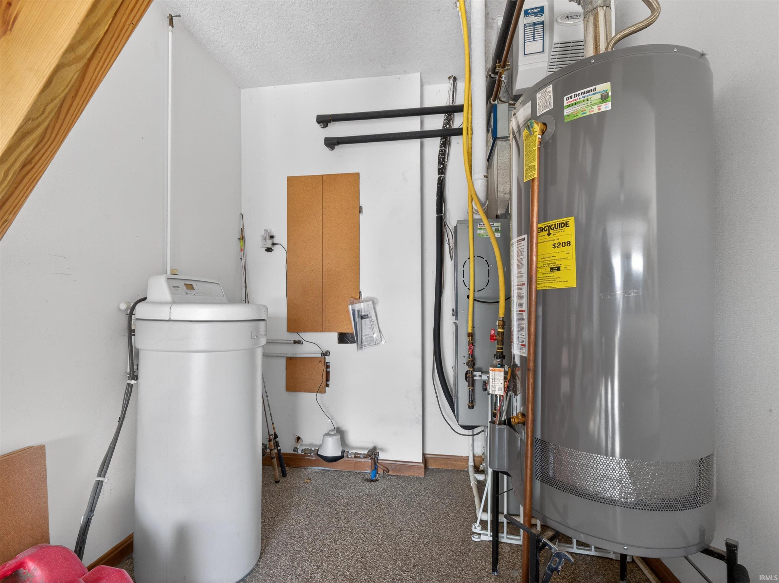 Utility area featuring water softener, HUMIDIFIER APRILAIRE, MANIFOLD WATER SYSTEM, 40 gallon gas hot water heater, peg boards.