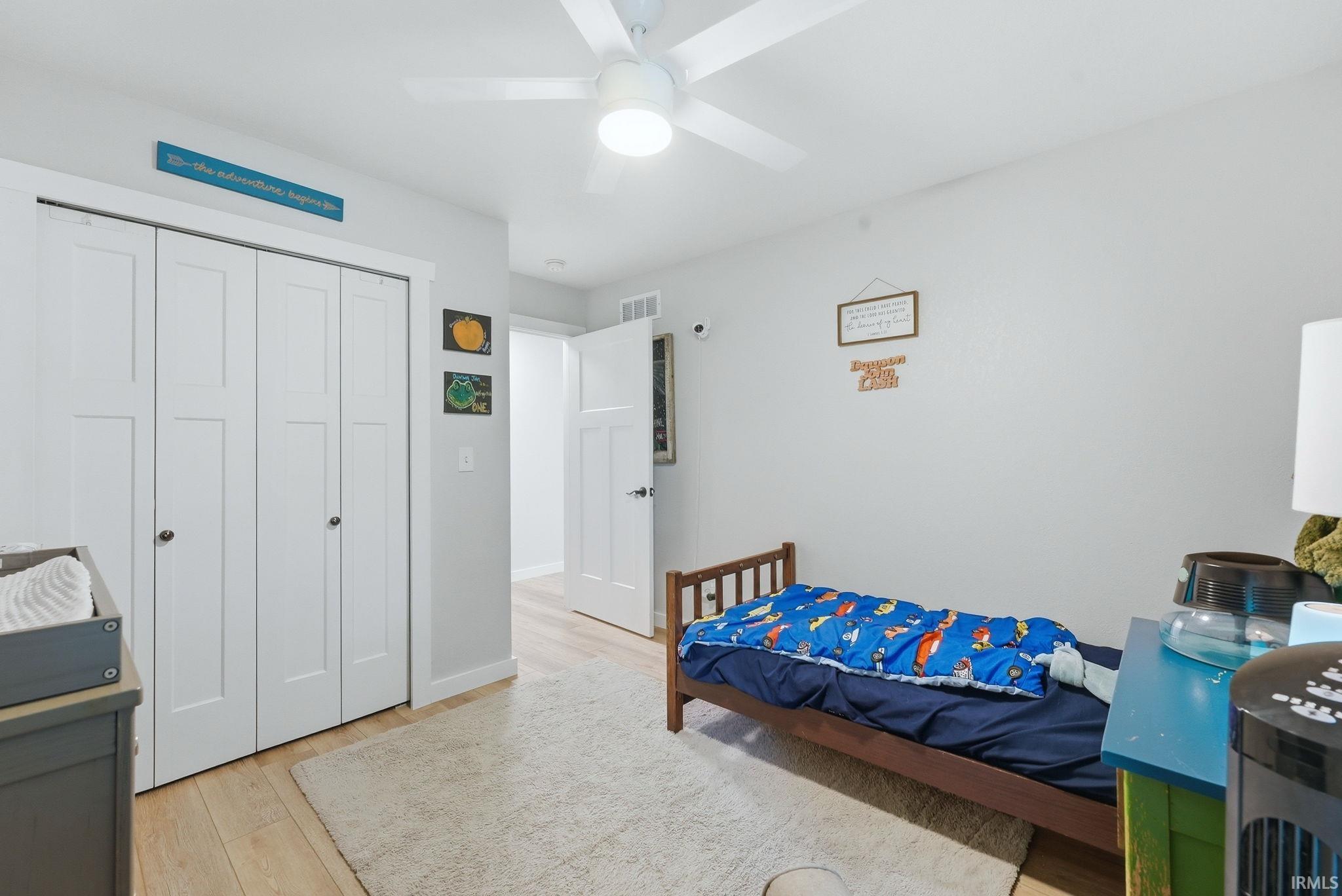 Light-toned wood-finish flooring complements the room's neutral wall color