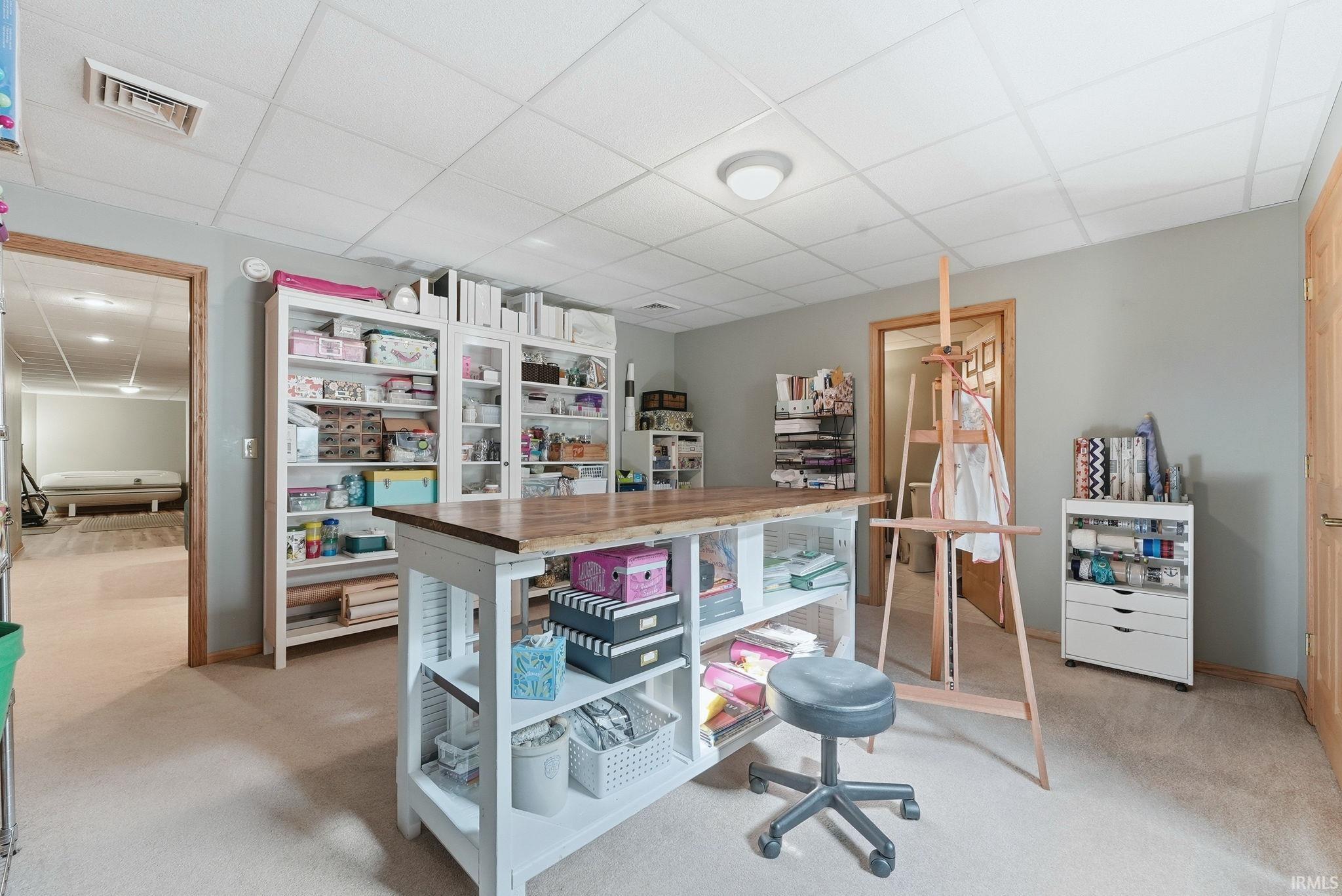 Spacious room featuring neutral wall paint and carpeted flooring