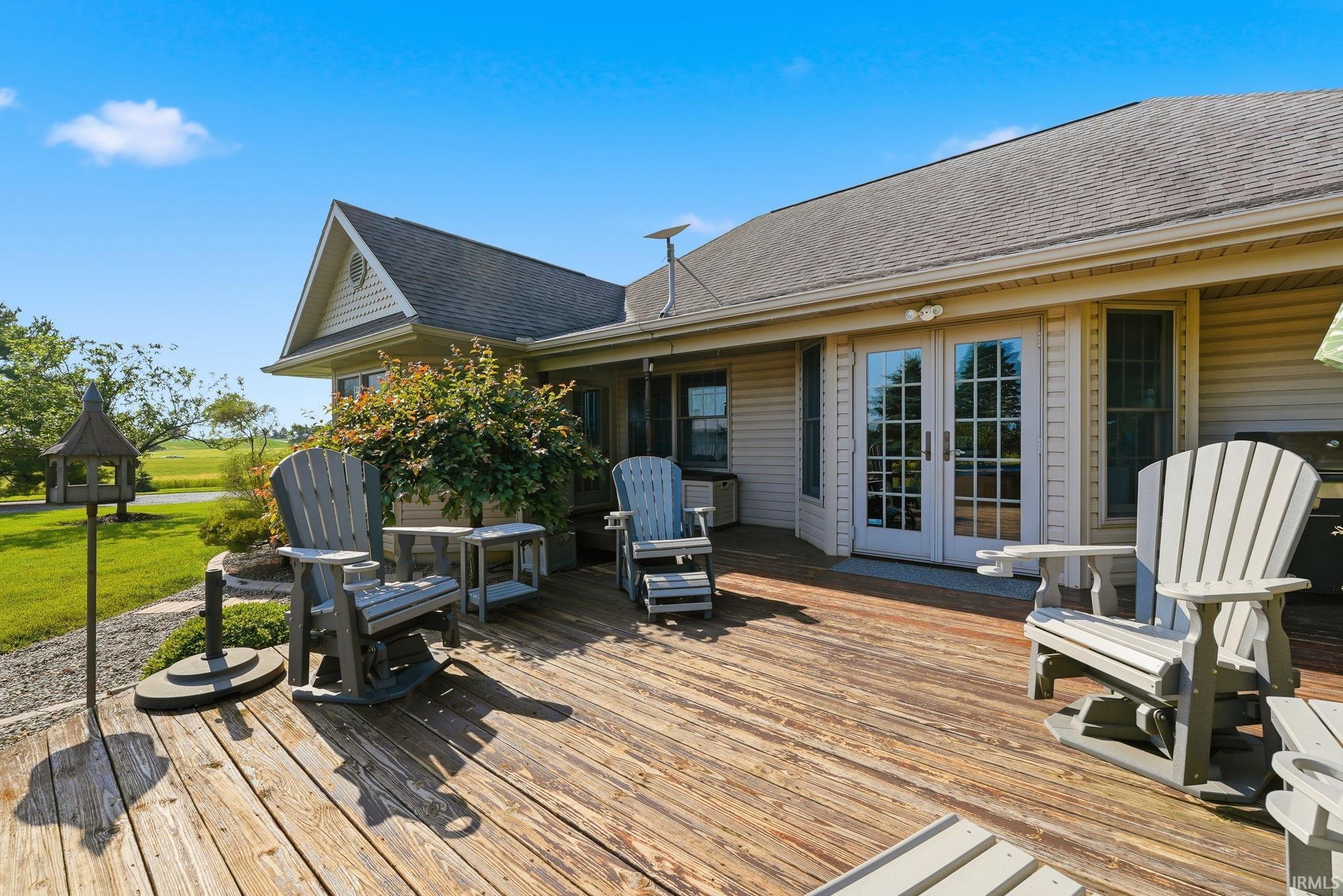 Expansive wood deck with direct access to interior spaces through French doors