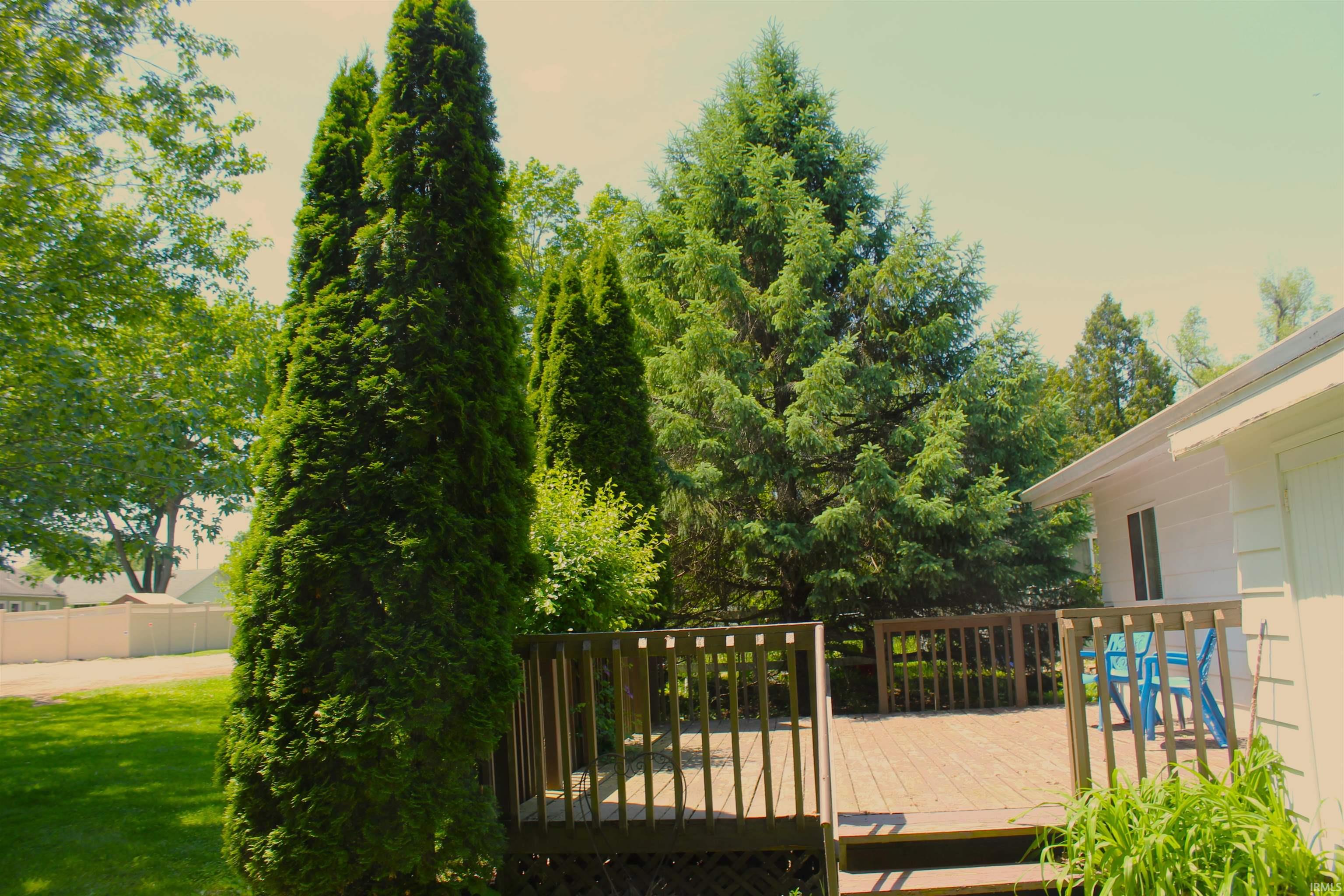Expansive exterior deck featuring wood railing and steps