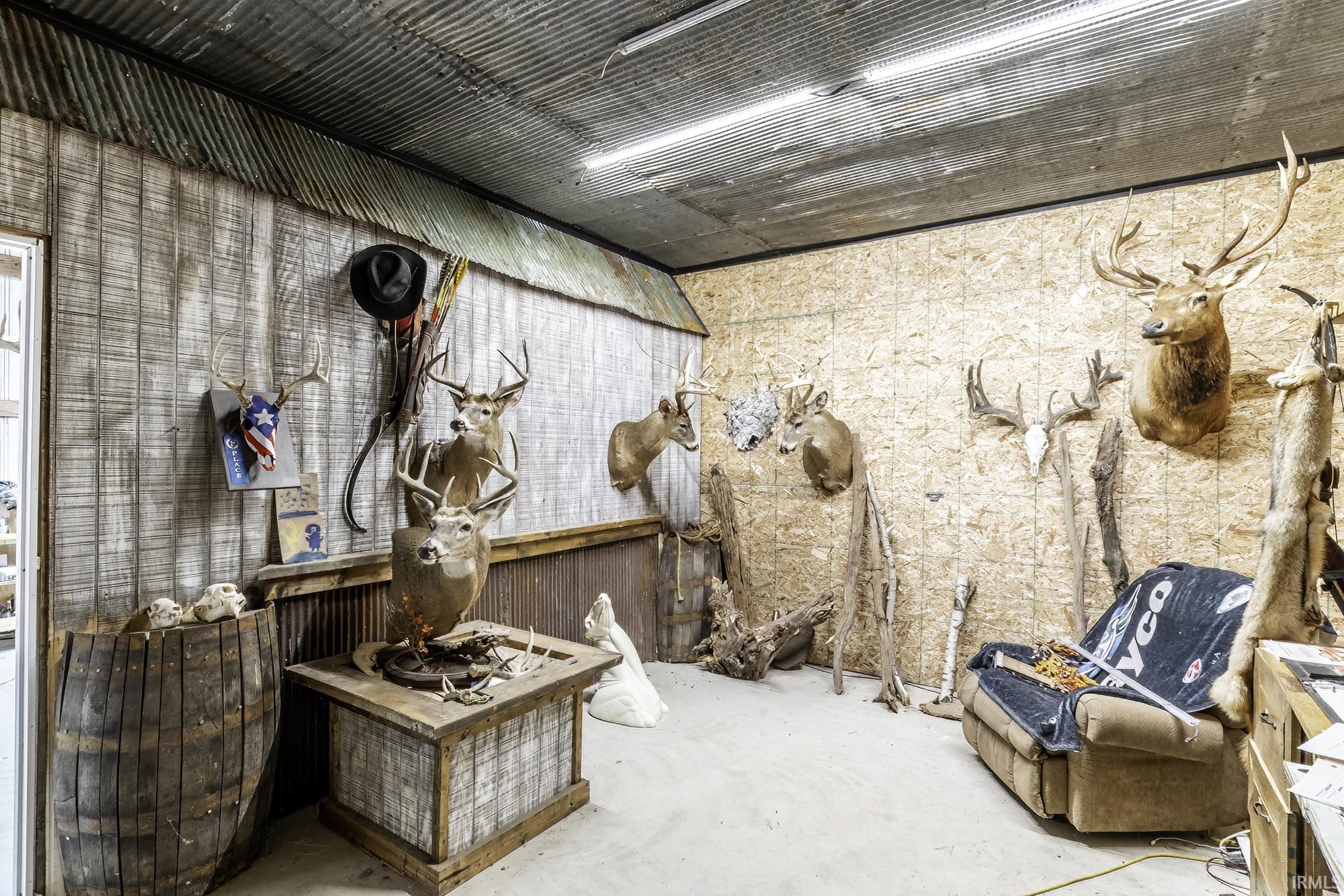 Interior space featuring corrugated metal ceiling, paneling, and engineered wood walls