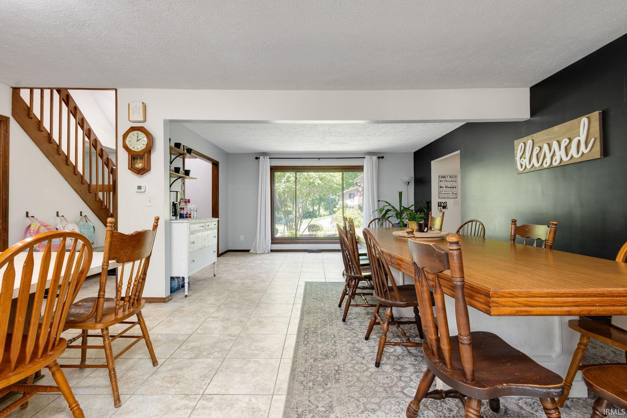 Dining area featuring a wood-finish table and tile flooring