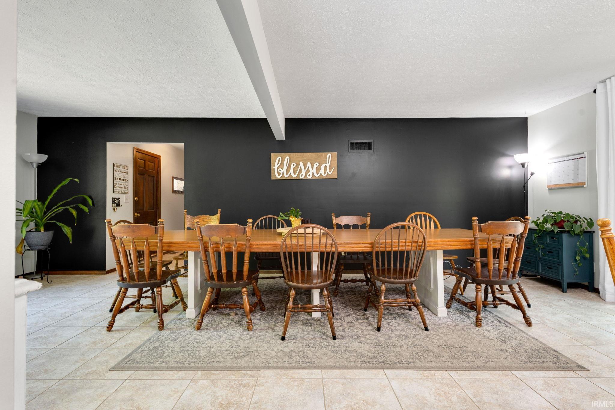 Spacious room with a feature wall, tile flooring, and an open doorway