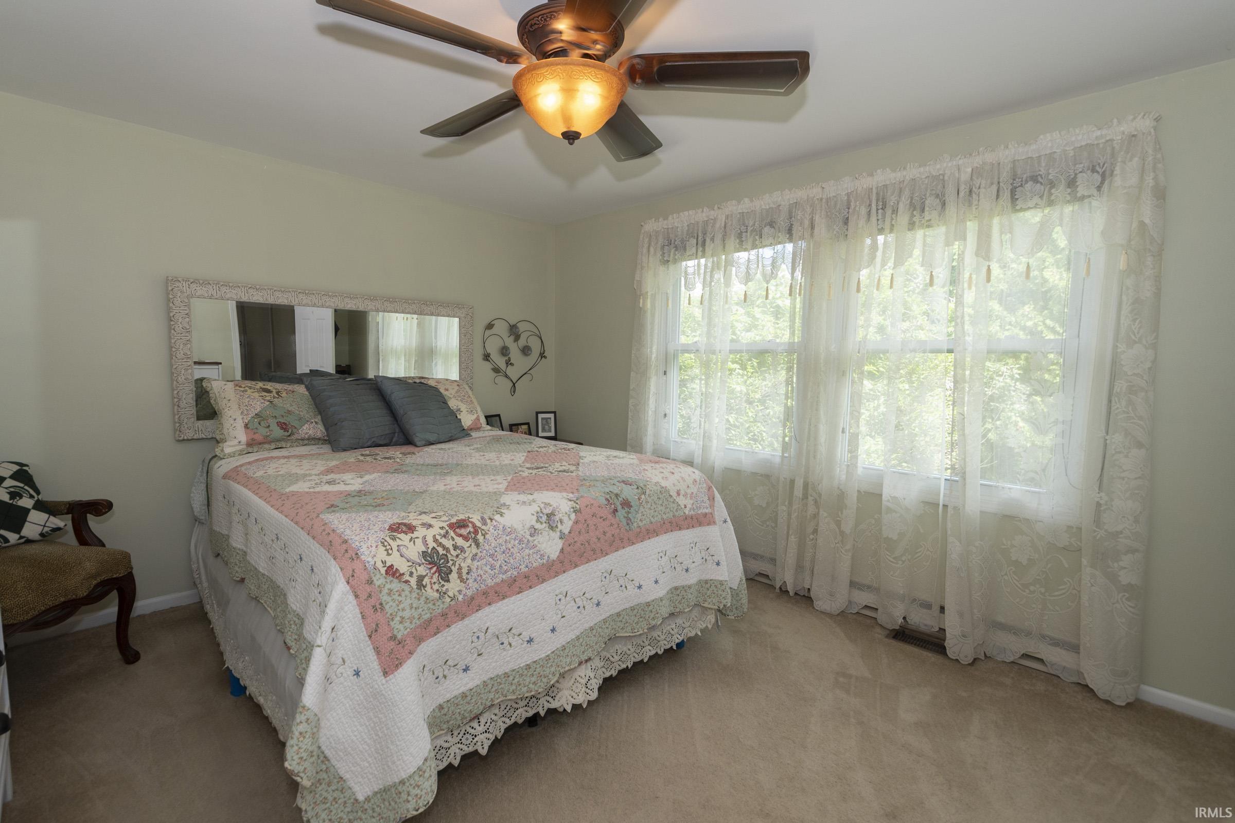 Room featuring light neutral wall paint and plush carpet flooring