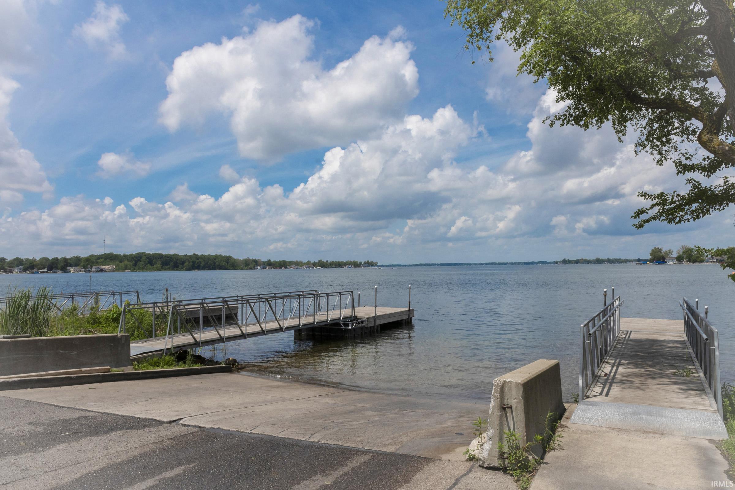 Waterfront property featuring two concrete boat ramps and two floating docks with metal gangways