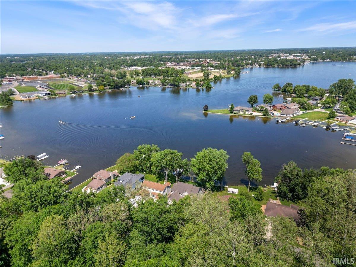 Expansive lakefront setting featuring multiple docks and surrounding residential properties