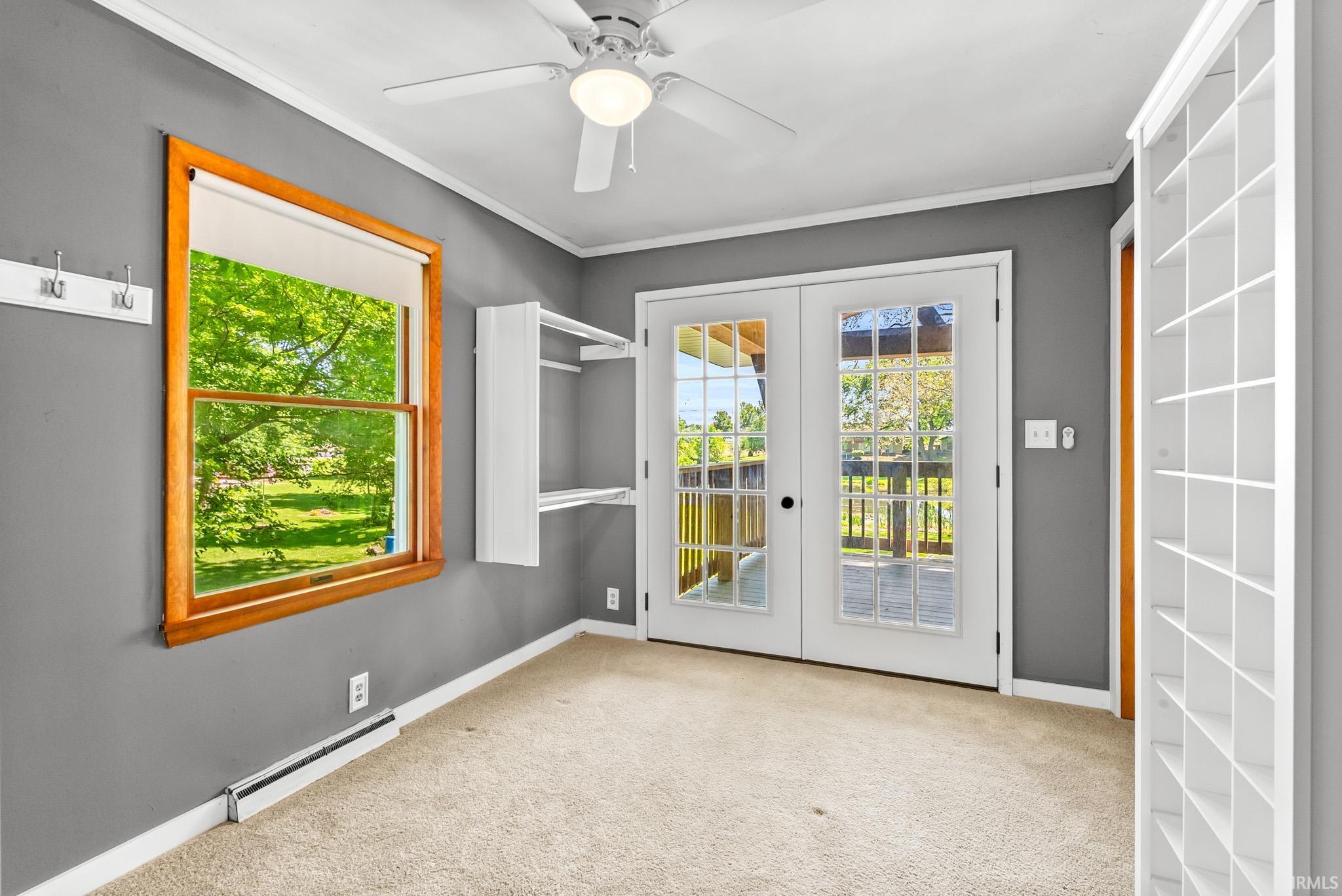 Double French doors with divided lites open to an outdoor deck