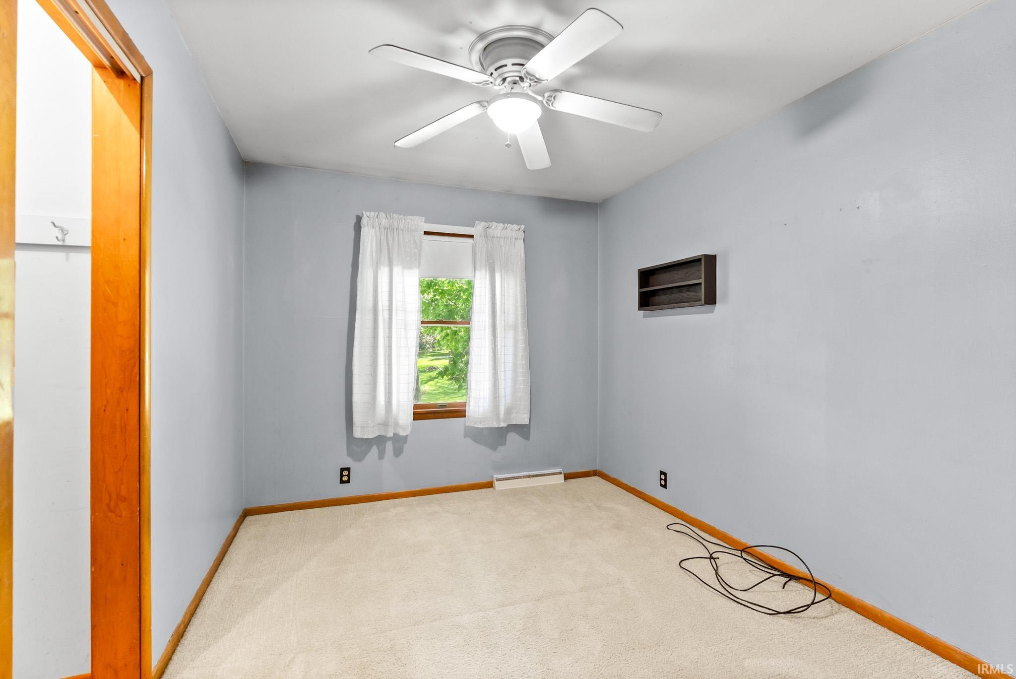 Neutral wall color complemented by light-toned carpet flooring