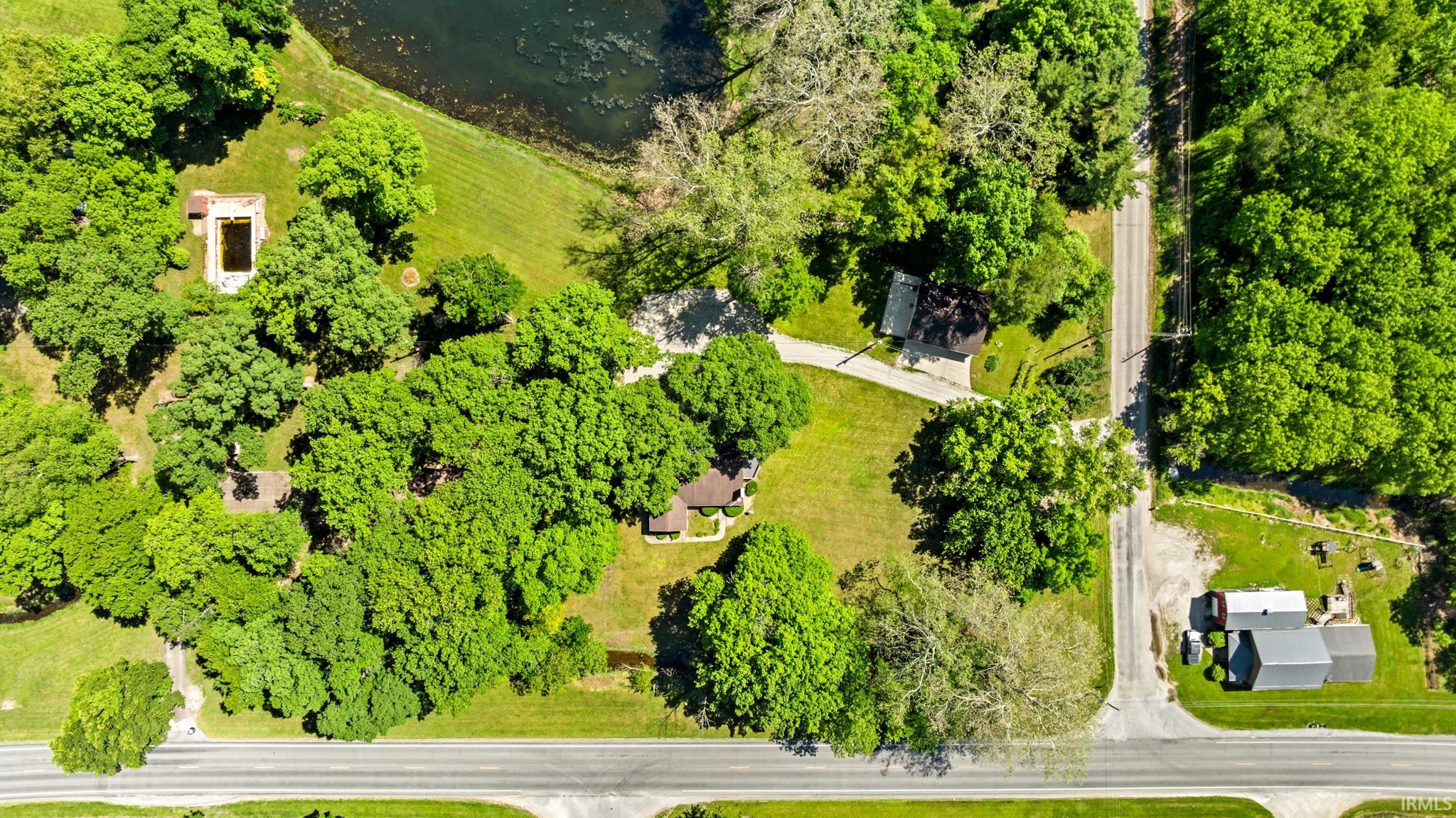 Expansive property featuring mature trees and lush green landscaping