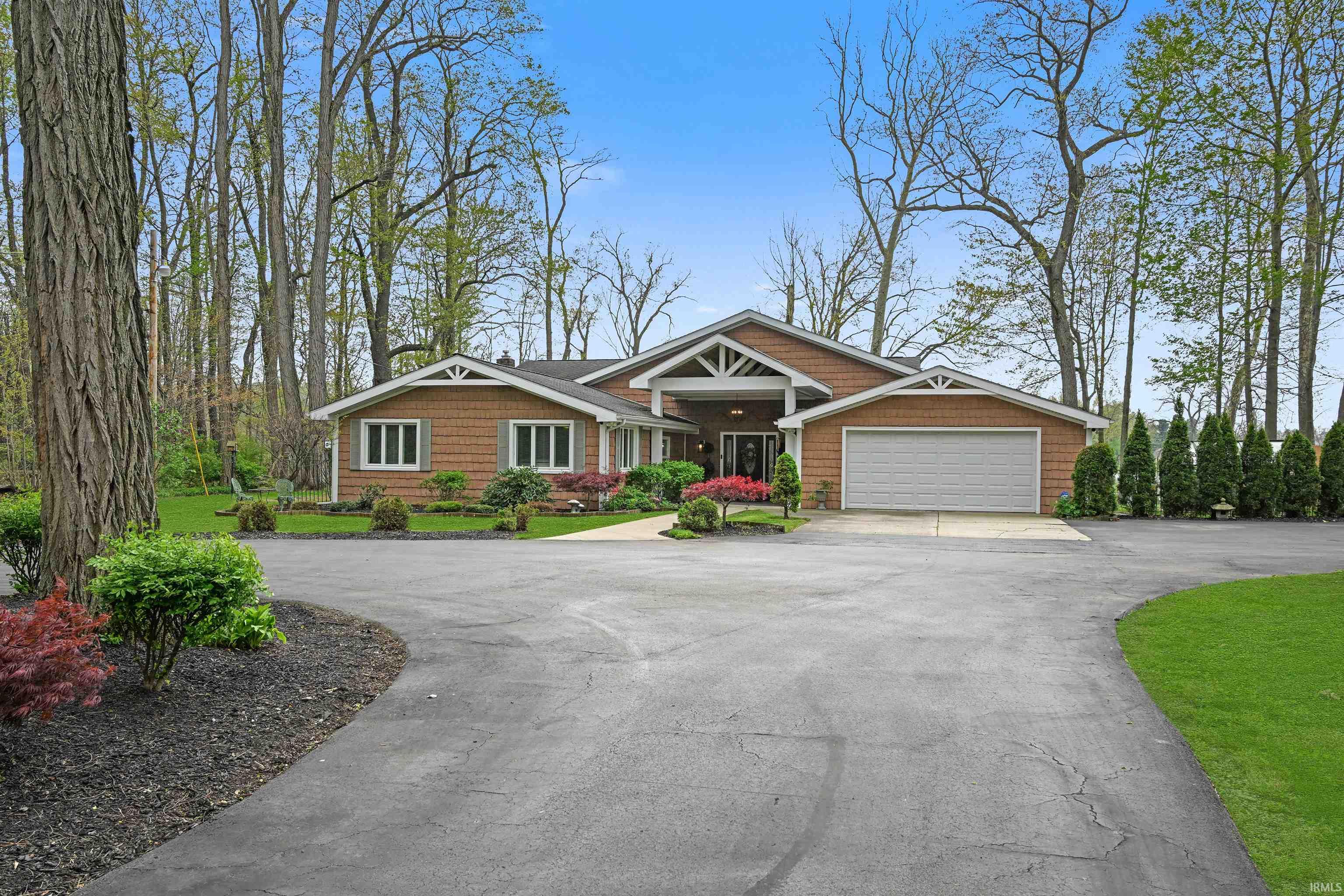 Ranch-style residence featuring cedar shake siding and white trim accents