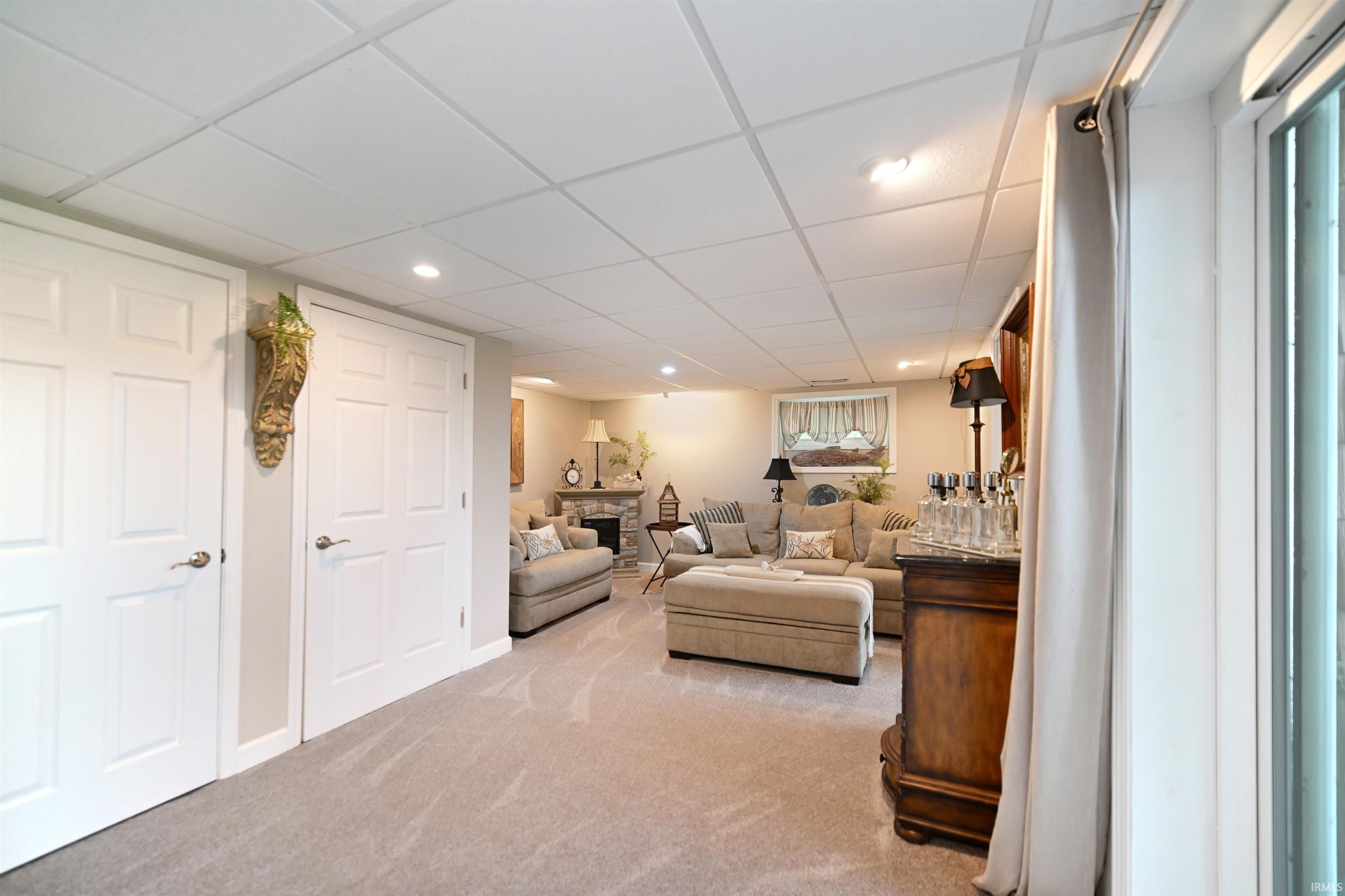 Finished lower level featuring recessed lighting, paneled doors, and carpeted flooring