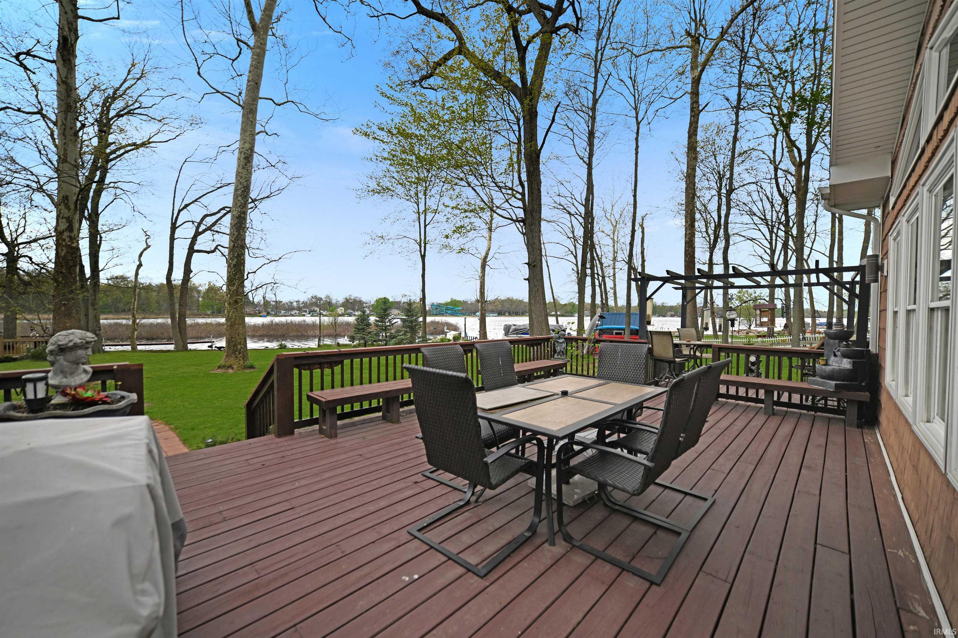 Spacious outdoor deck featuring wide plank composite decking, railing, and built-in benches