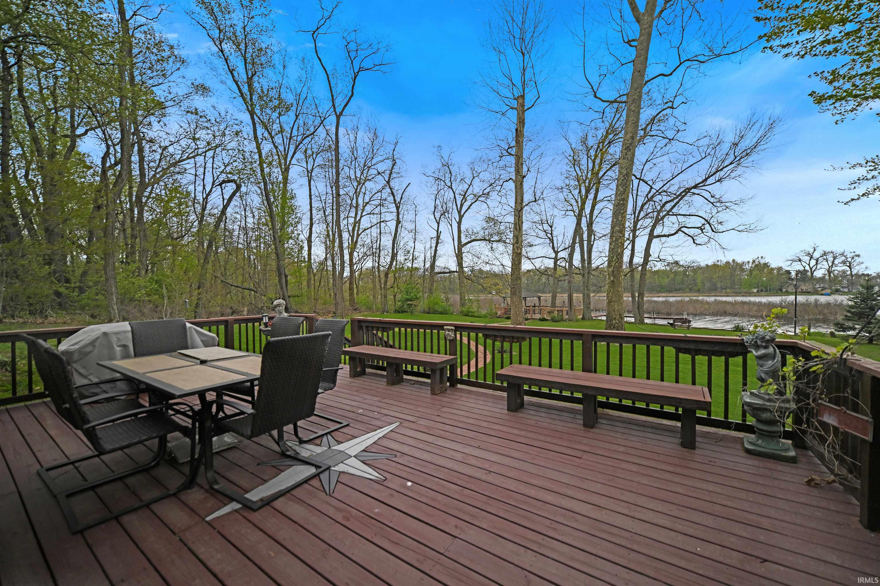 Expansive wood-finish deck featuring a compass rose inlay and dark wood railing