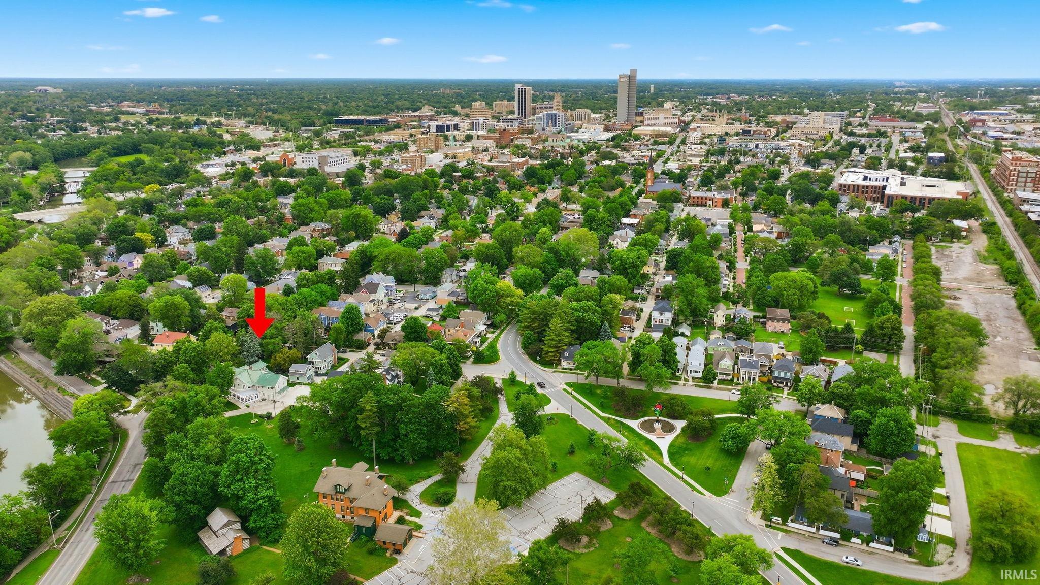 Aerial perspective showcasing a residential neighborhood with mature trees