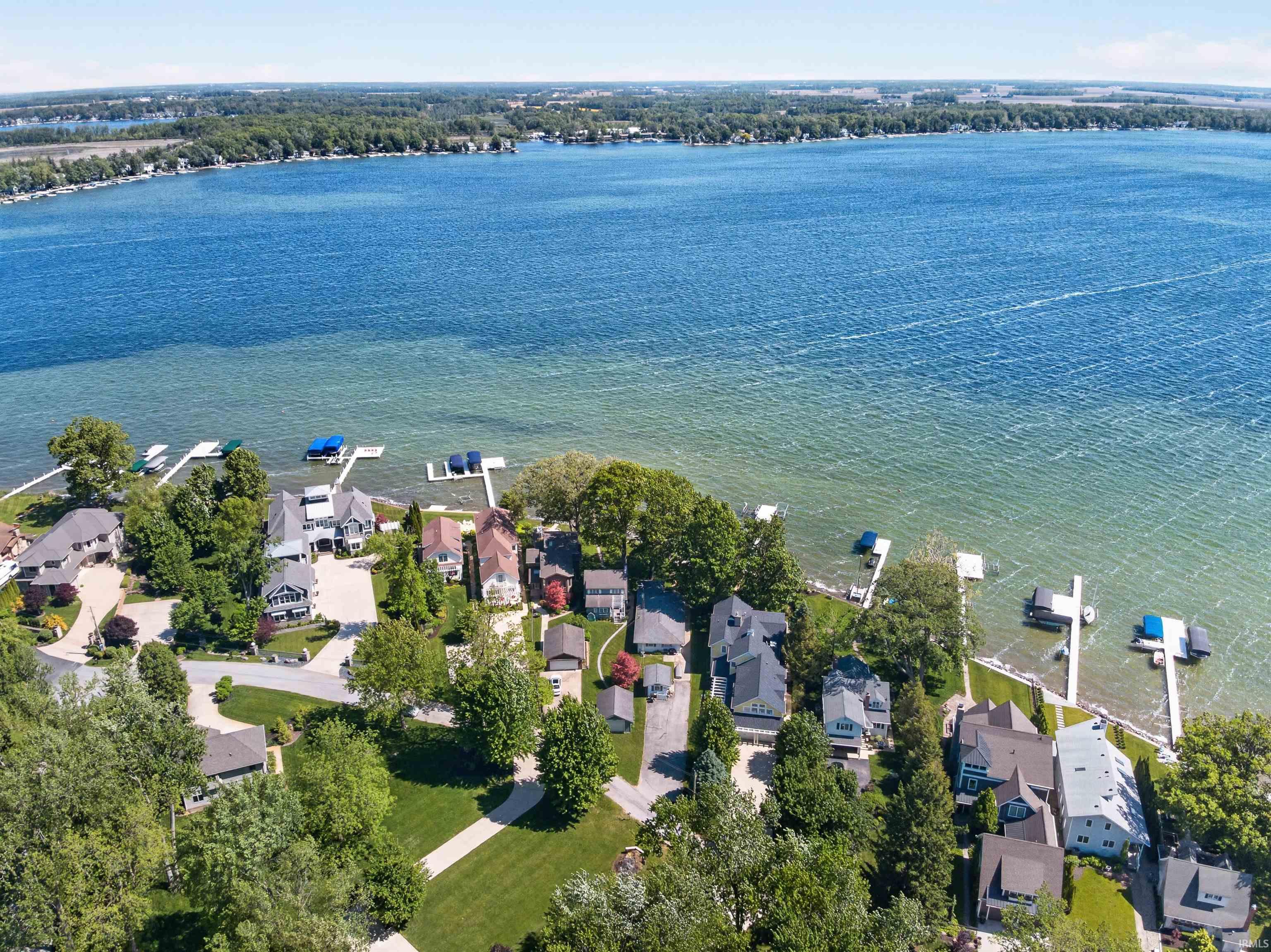 Expansive waterfront property featuring multiple residential homes along a large body of water