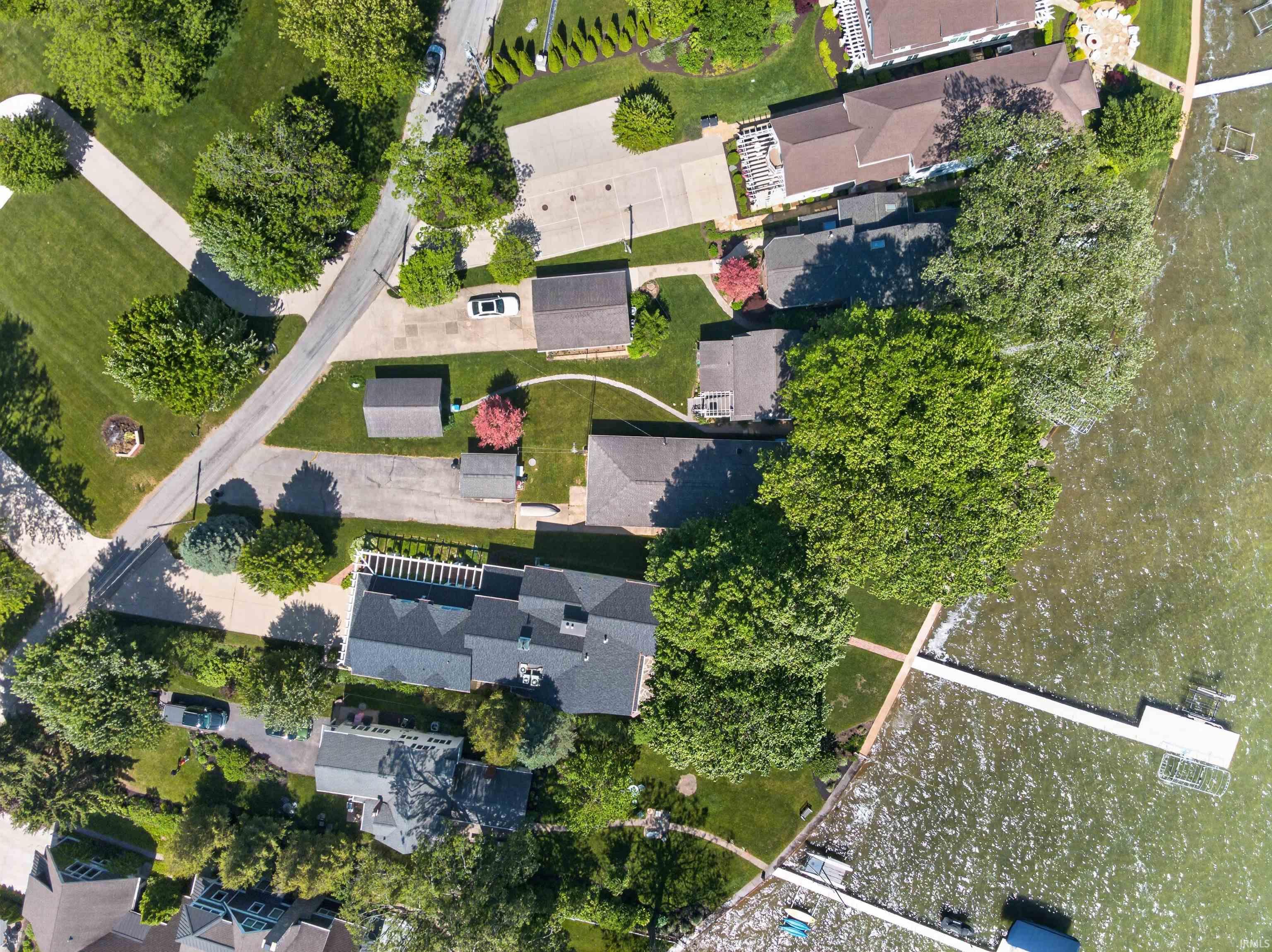 Aerial view showcasing multiple properties with waterfront access